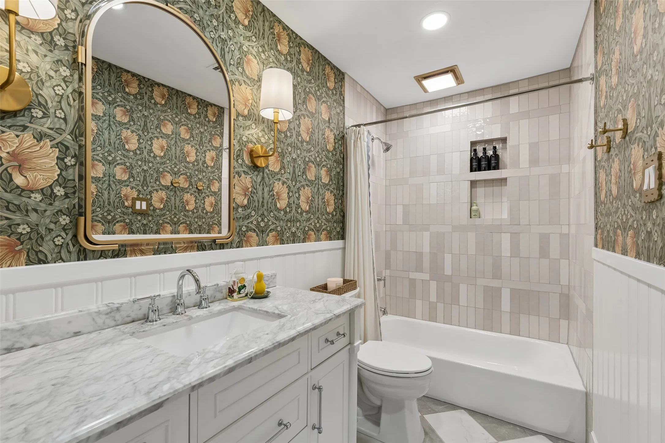 Hall bath with Morris & Co. wallpaper, marble counter vanity, zellige shower tile and harlequin floor tile.