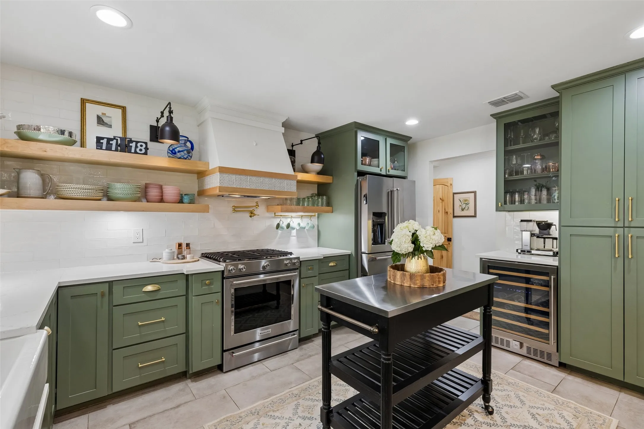 5 burner gas range and ventahood. Open wood shelving for storage.