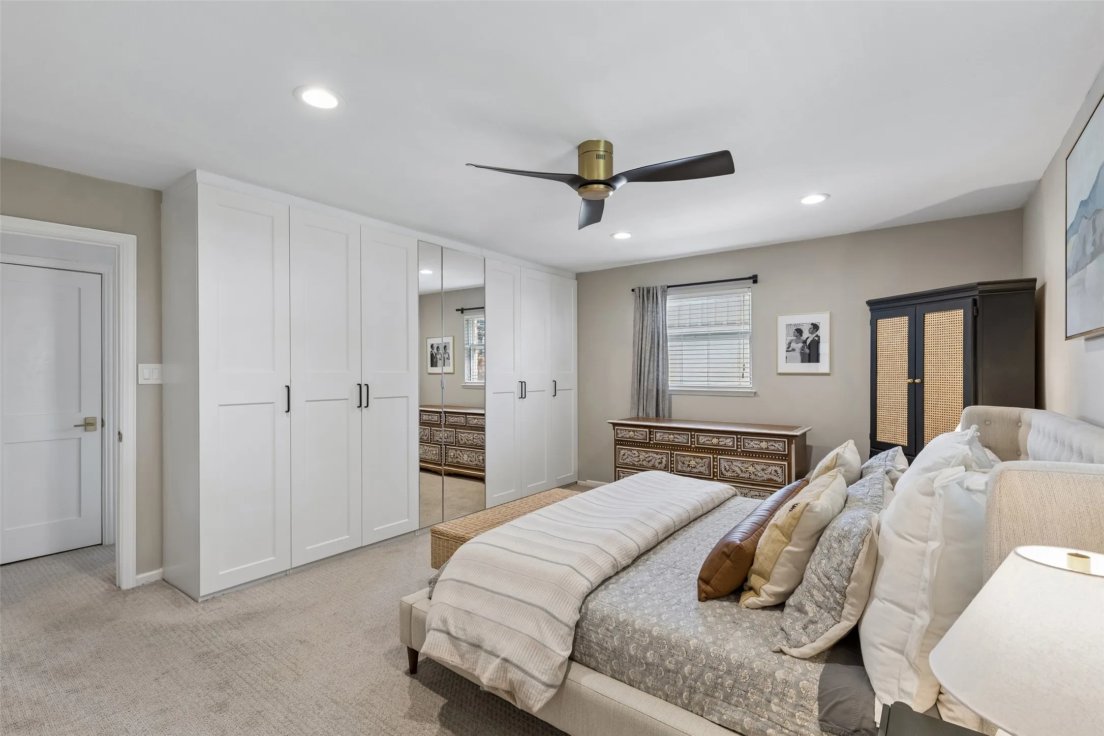 Primary bedroom with built in wall wardrobe closet