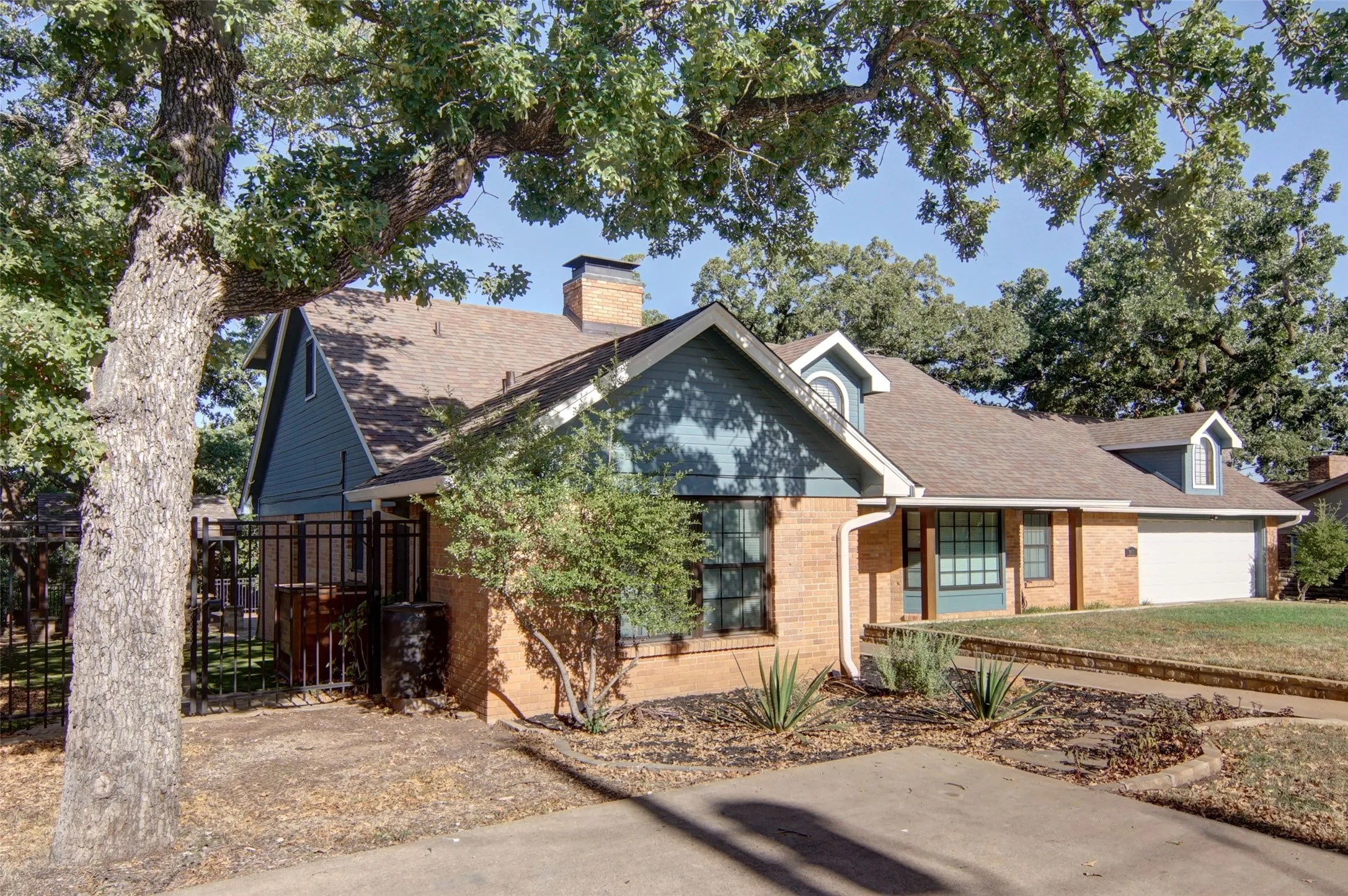 Nice trees, landscaping, wrought iron fence