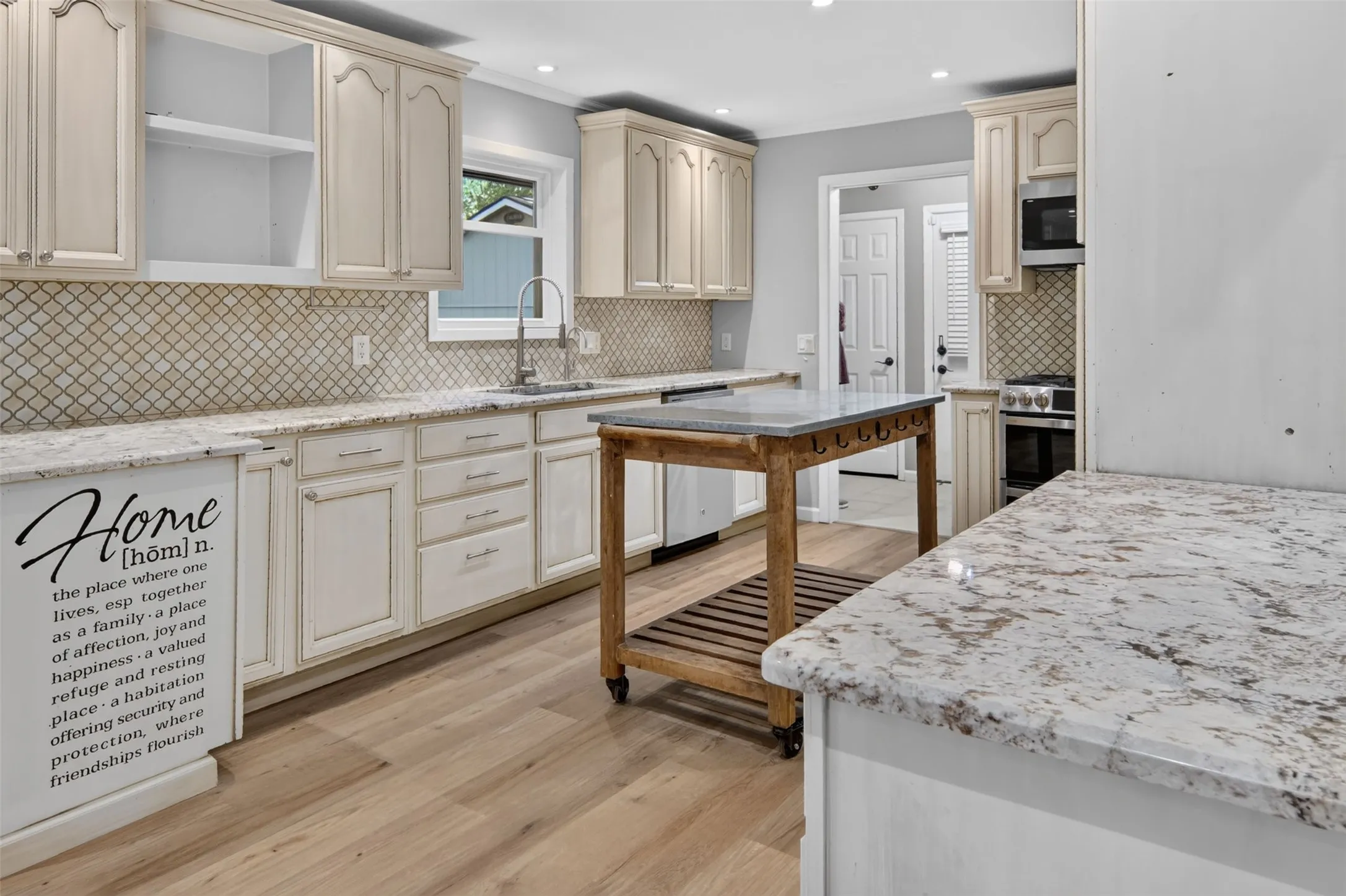 Amazing kitchen with granite countertops a custom made island, and exquisite tile backsplash