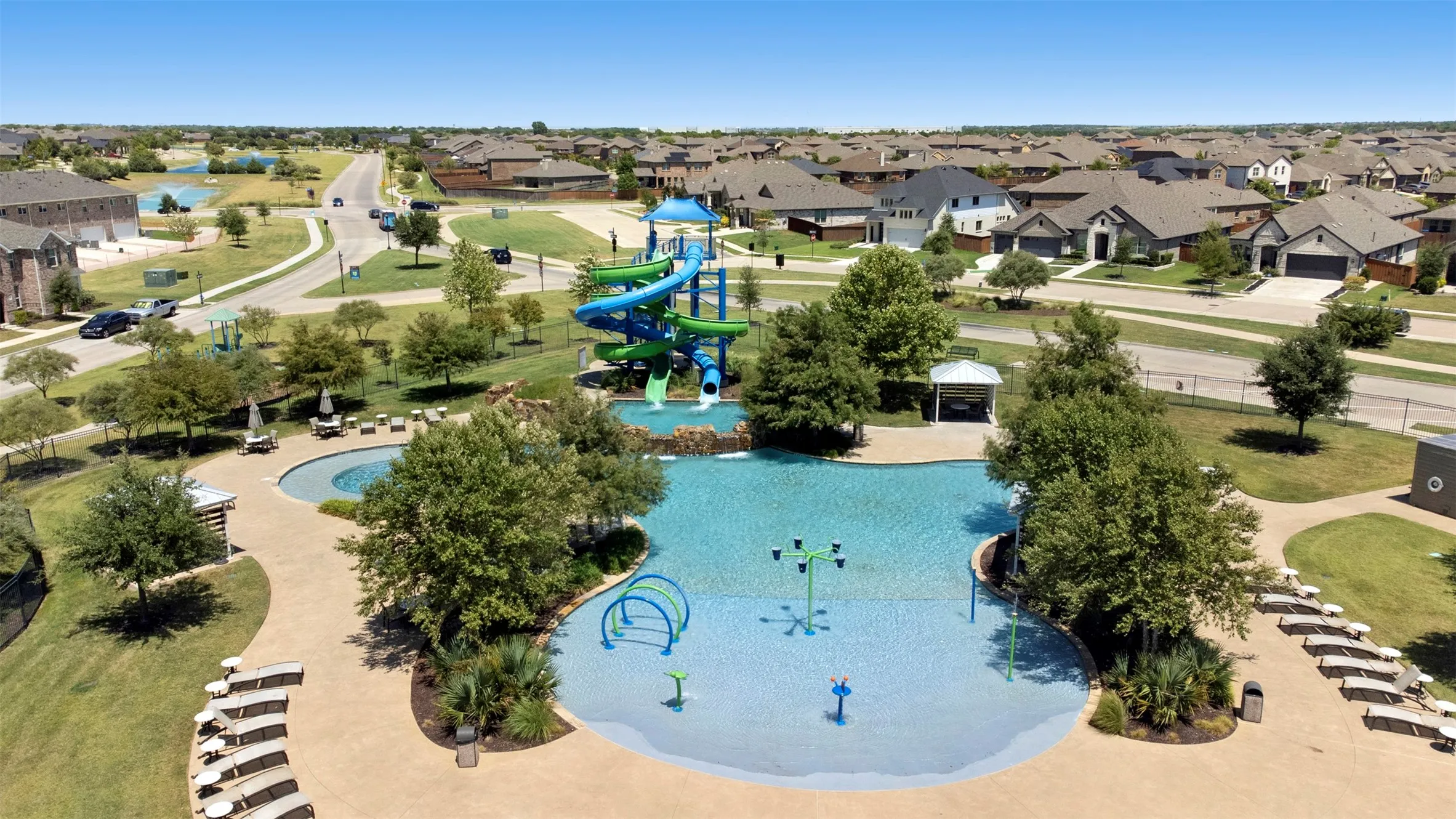 Community swimming pool with water slides and built-in water features