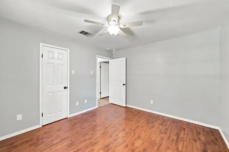 Wood-finish flooring with light gray wall tones and white trim