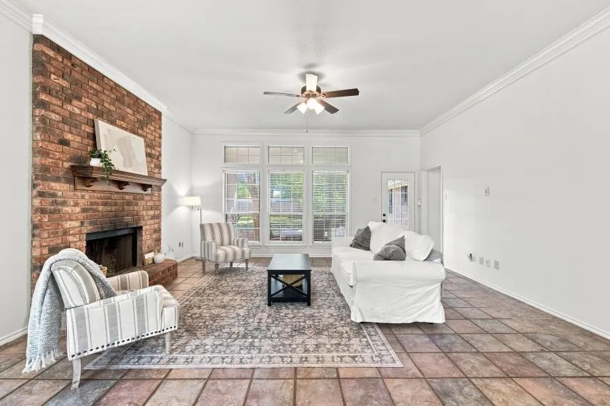 Brick-faced fireplace with a wood mantel