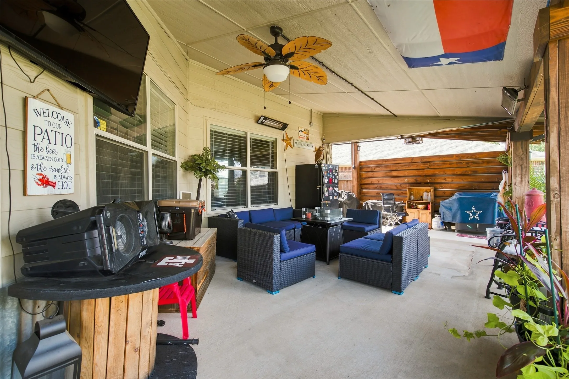 Covered patio with a ceiling fan, recessed lighting, and a wall-mounted television