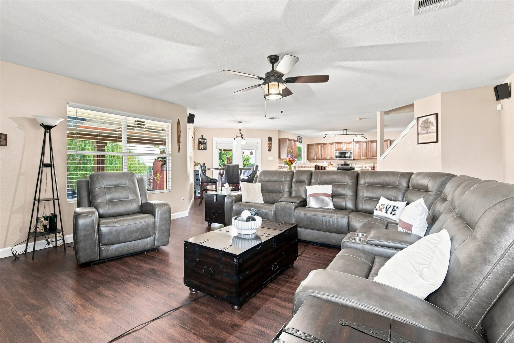 Expansive living area featuring wood-finish flooring, a ceiling fan, and recessed lighting