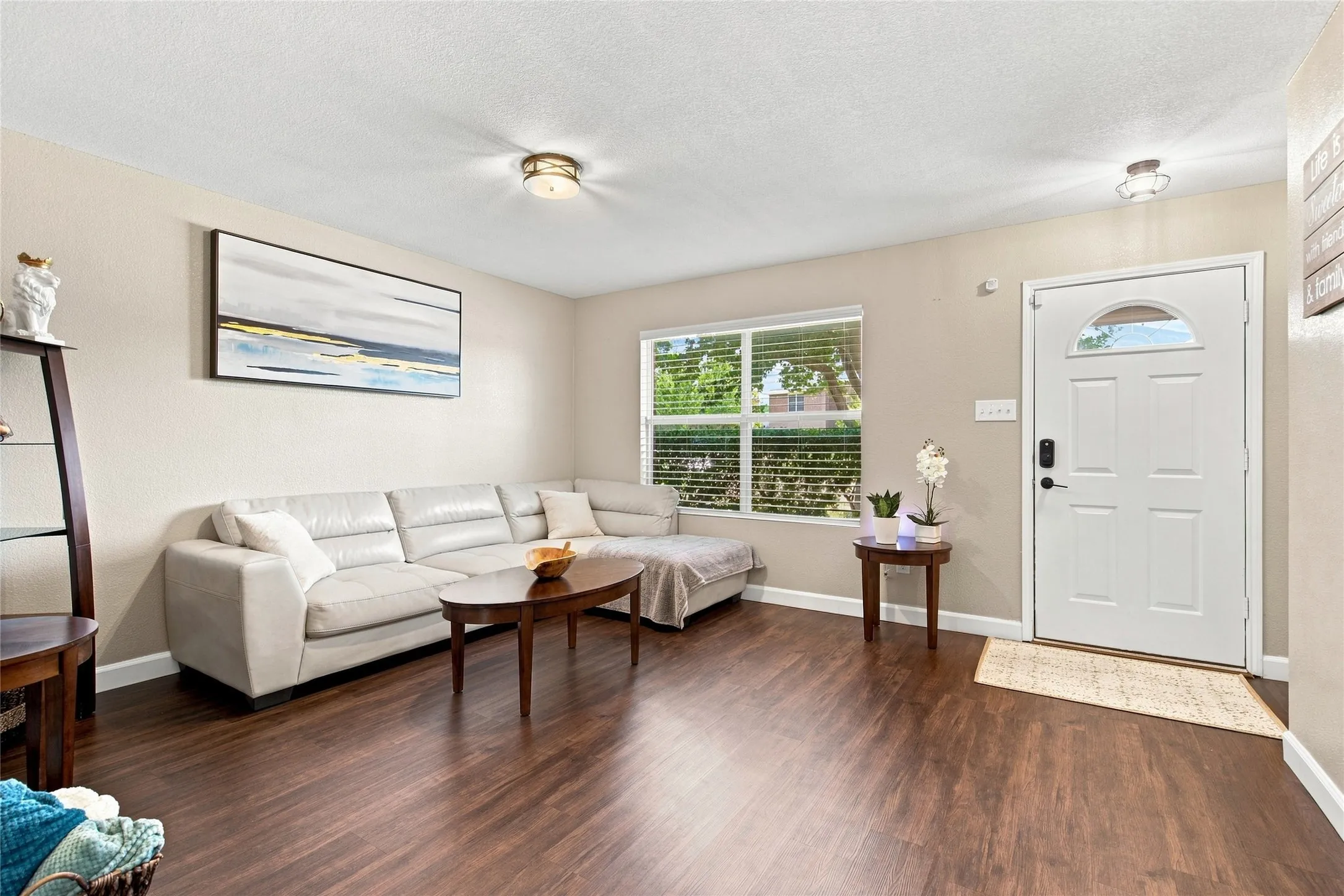 Warm wood-finish flooring complements neutral wall tones