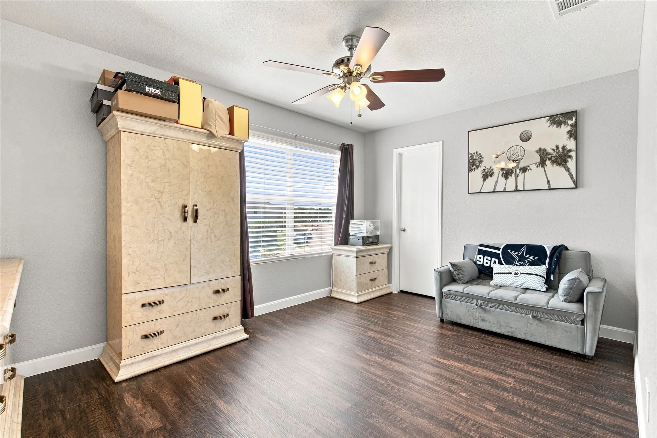 Wood-finish flooring with light gray wall paint and white trim