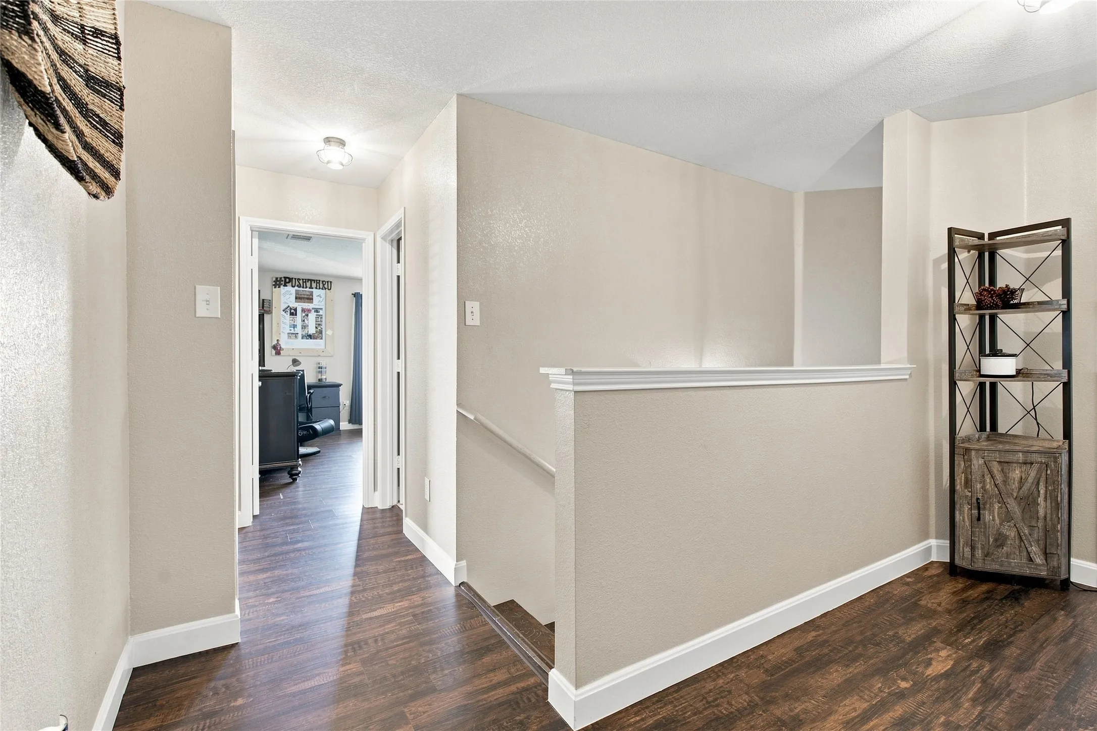 Wood-finish flooring throughout, light-toned wall paint, and white trim accents
