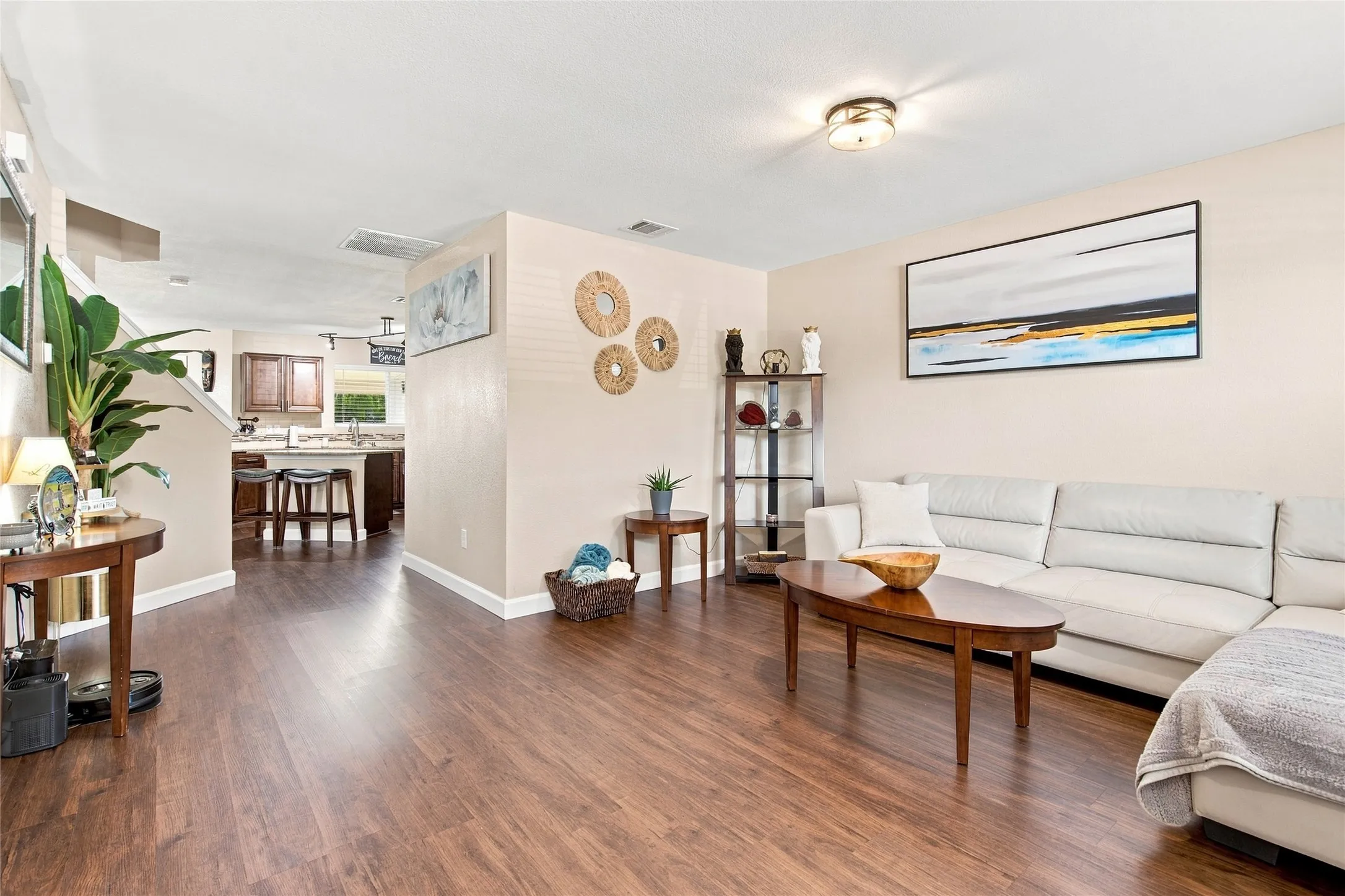 Wood-finish flooring throughout, neutral wall tones, and recessed lighting