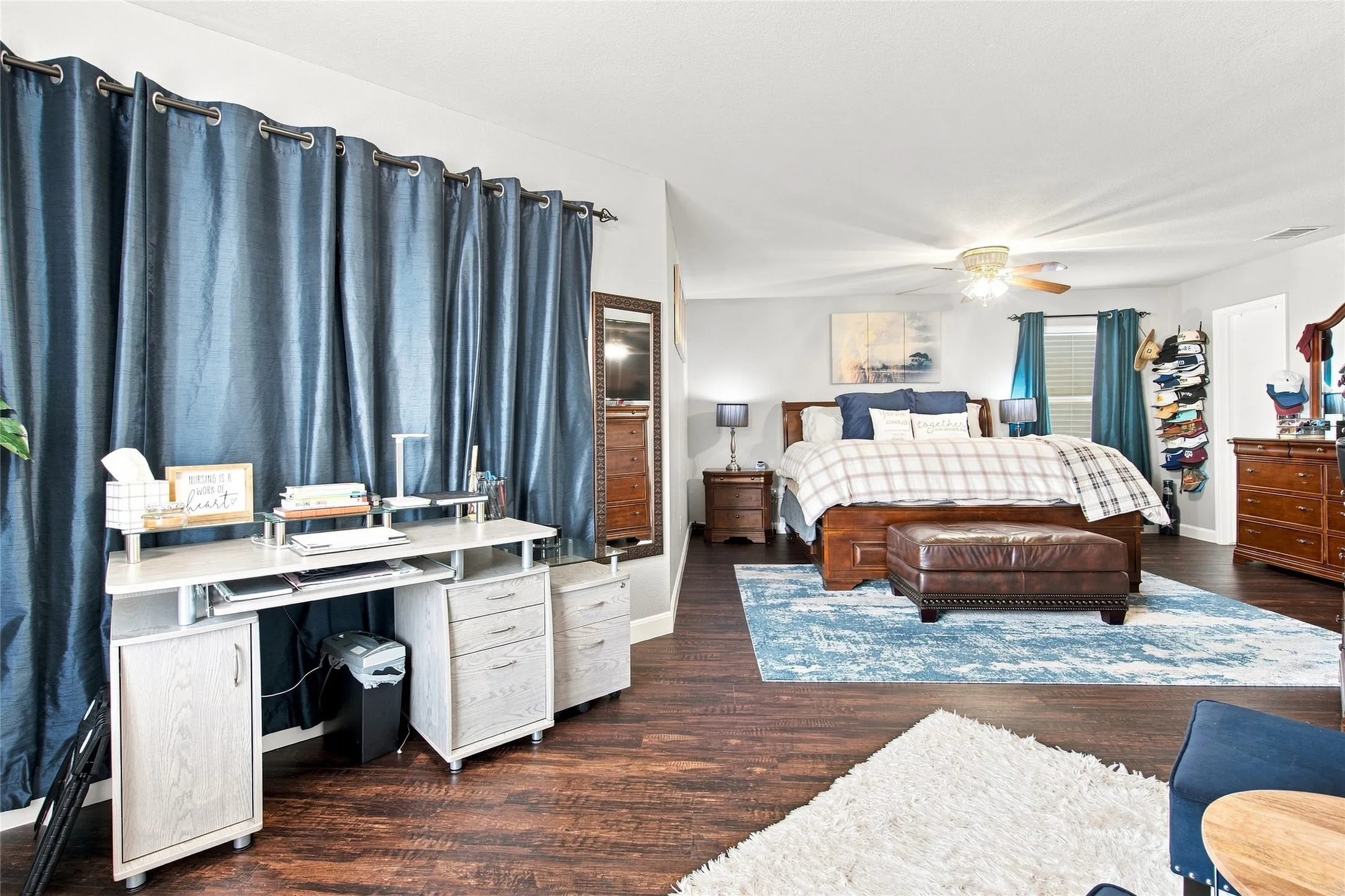 Wood-finish flooring throughout, complemented by a ceiling fan with integrated lighting