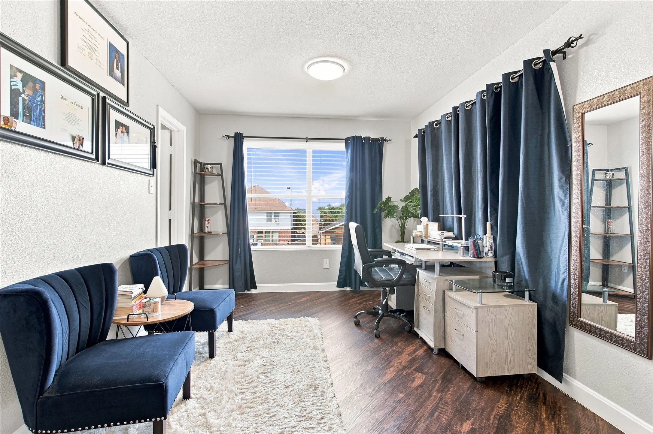 Recessed lighting, wood-finish flooring, and a large window with blinds