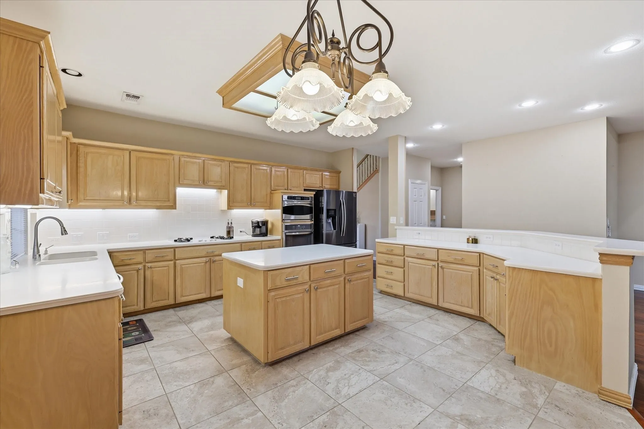 Plenty of workspace in this oversized kitchen with sit up breakfast bar and decorative lighting