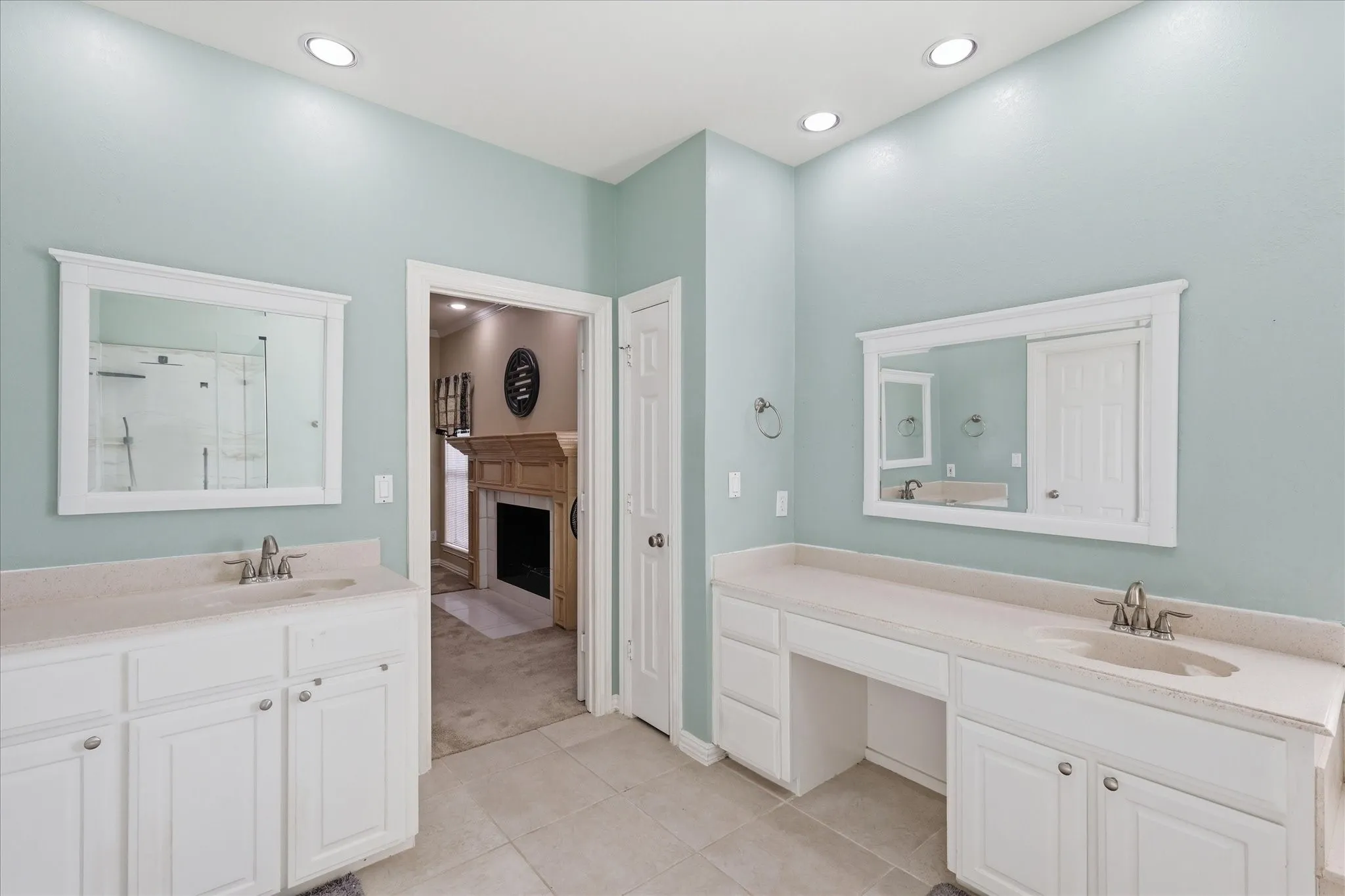 Large primary bathroom with separate vanities, separate shower-tub and large walk-in closet