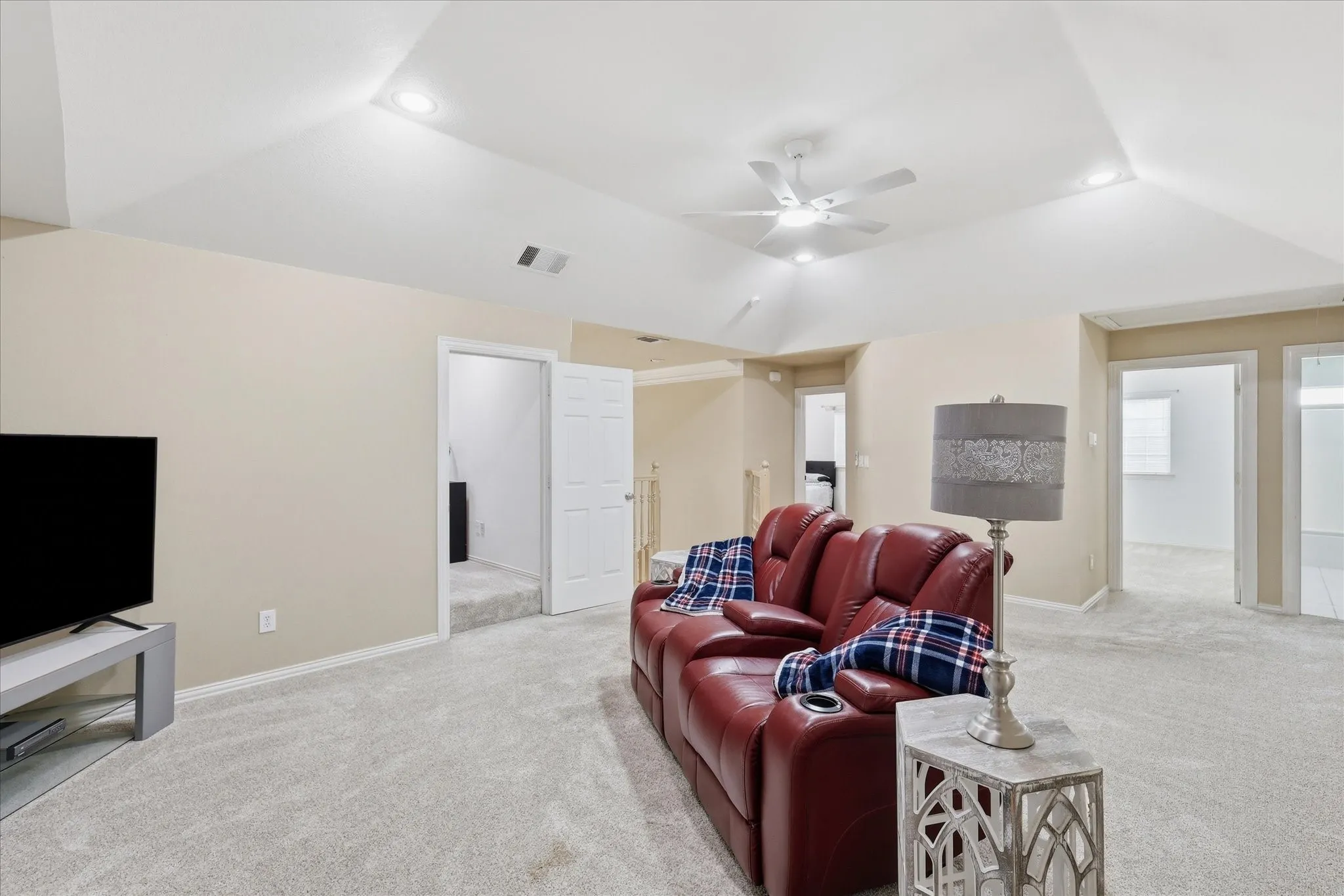 Another view of upstairs game room area featuring vaulted ceilings