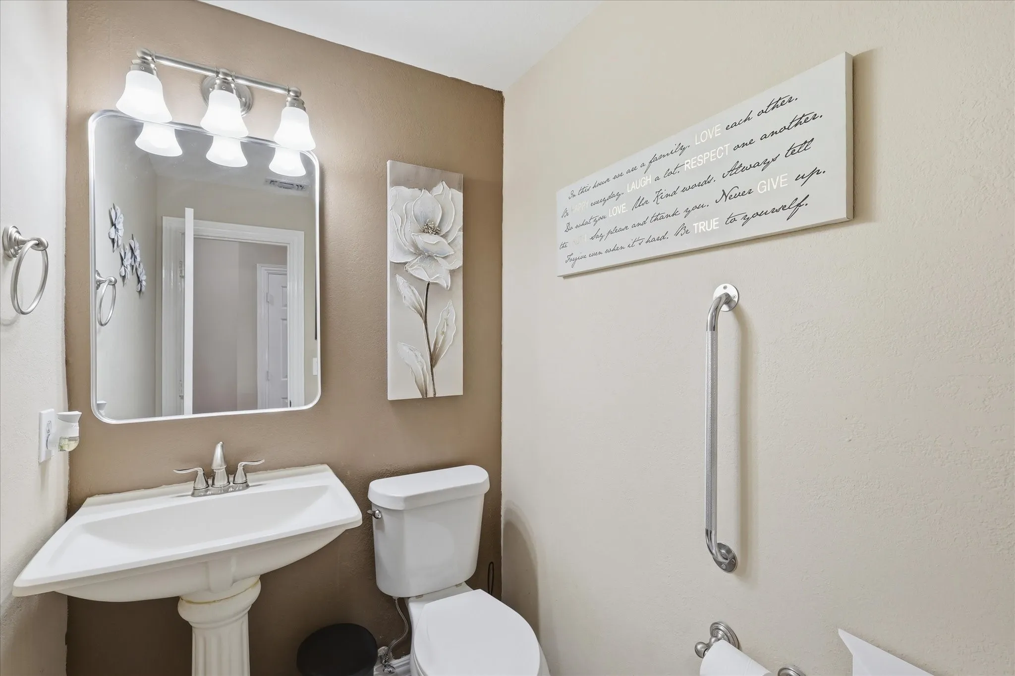 Downstairs half bathroom near kitchen area