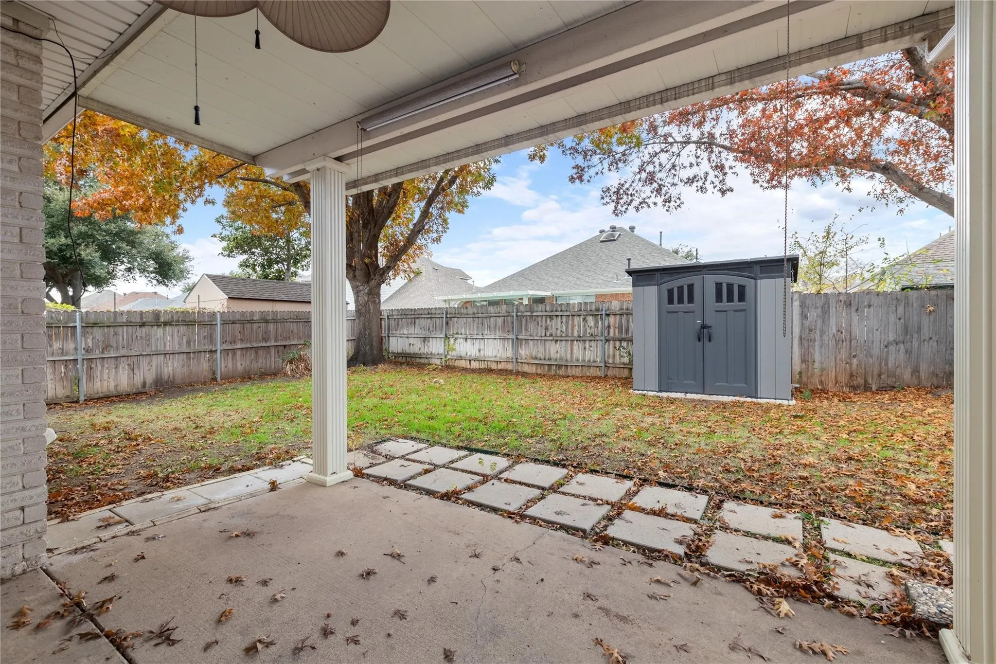 Covered patio with concrete flooring and integrated square stepping stones
