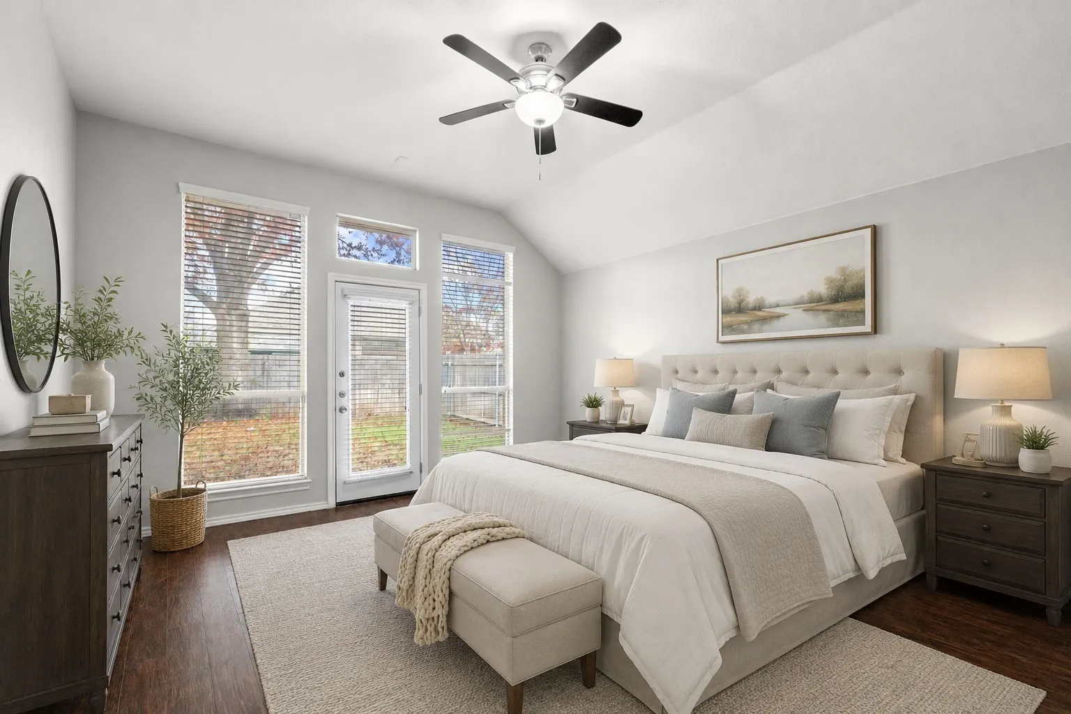 Vaulted ceiling with a ceiling fan, direct outdoor access, wood-finish flooring, and multiple windows