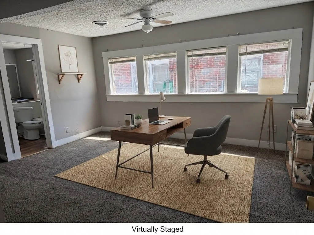 Carpeted flooring with a built-in ceiling fan and overhead lighting