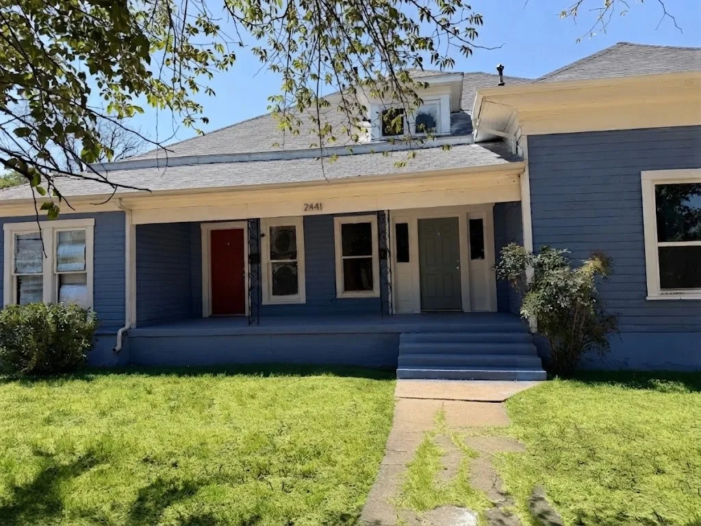 Blue siding exterior with white trim and a gabled roof