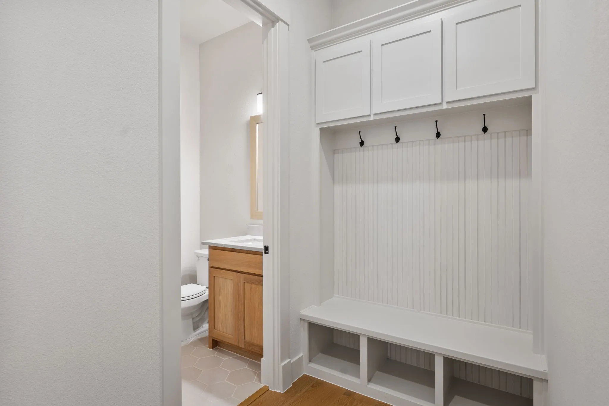 Your new owner's entrance features a built in mud bench and half bath.