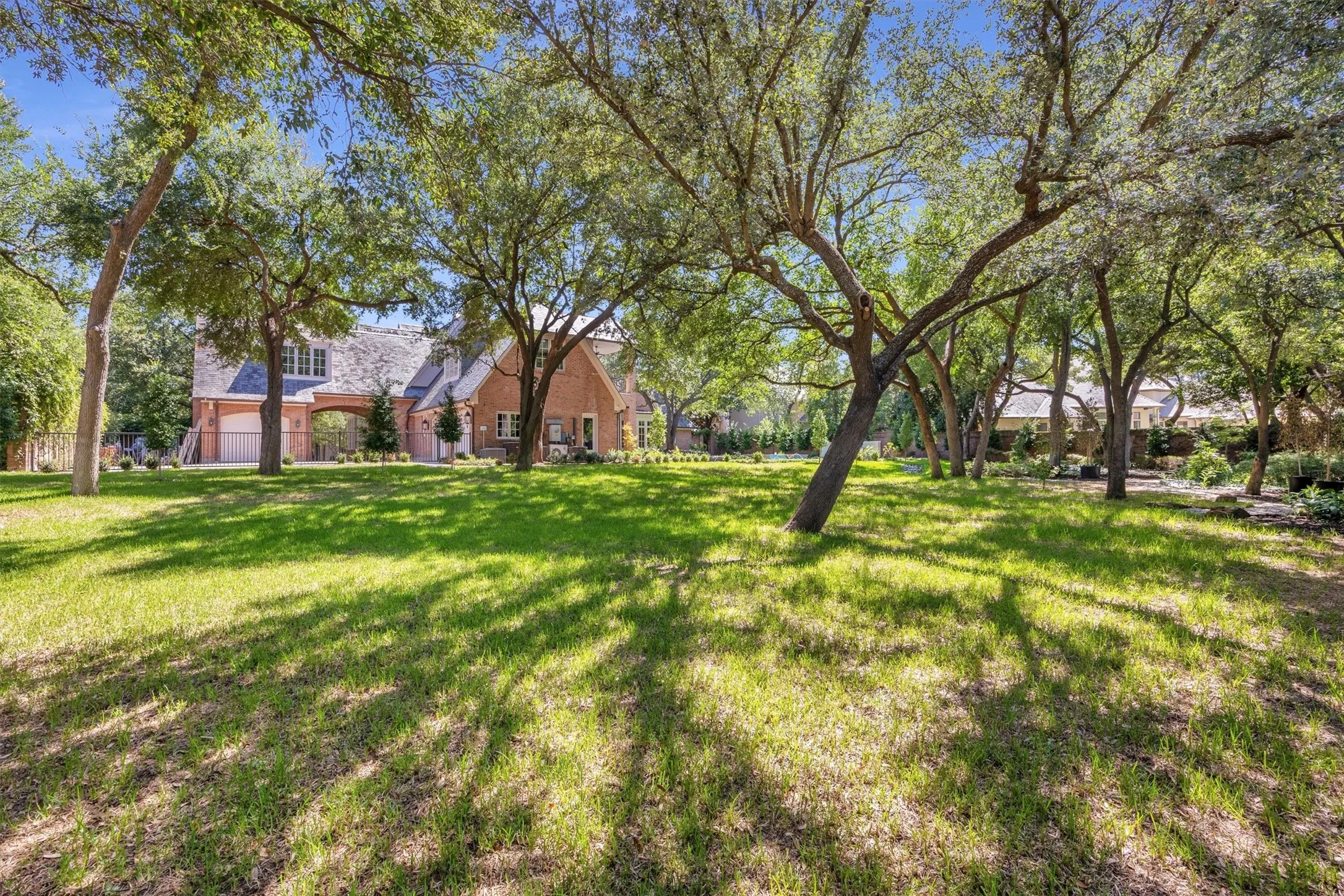 Back yard, a canopy of established oak trees and gorgeous landscaping.