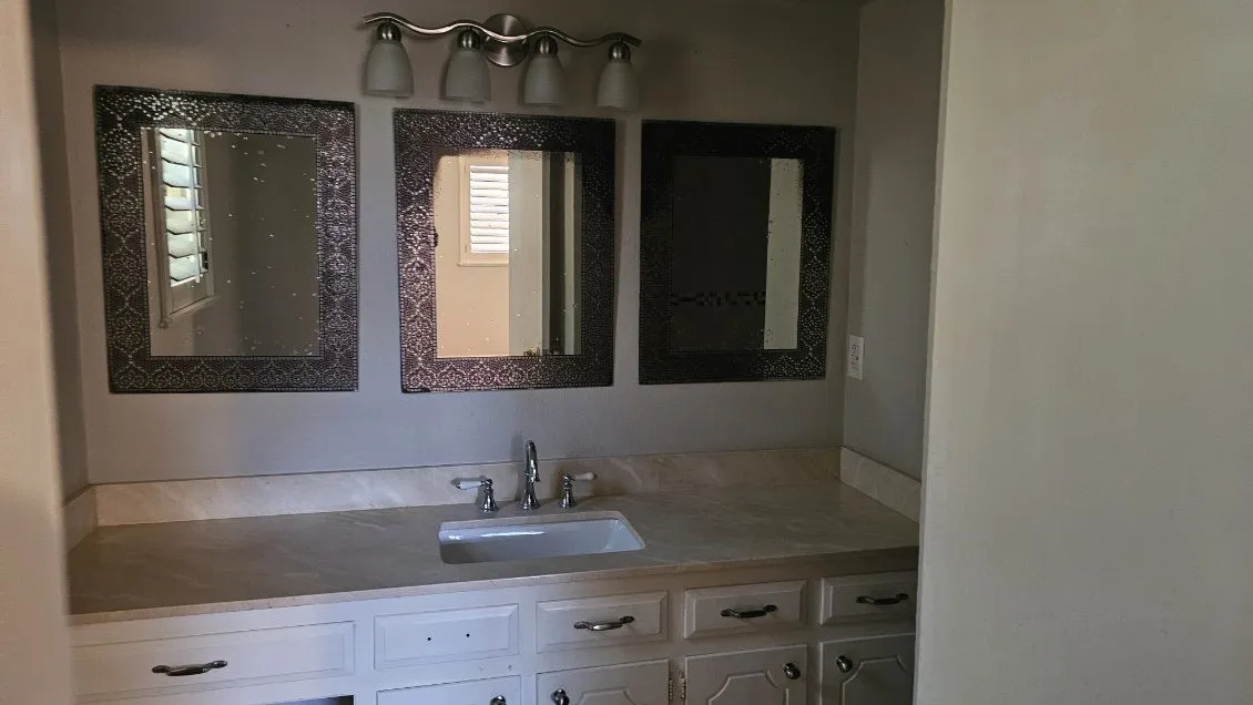 Double vanity with undermount sink, brushed nickel faucet, and a light-toned countertop