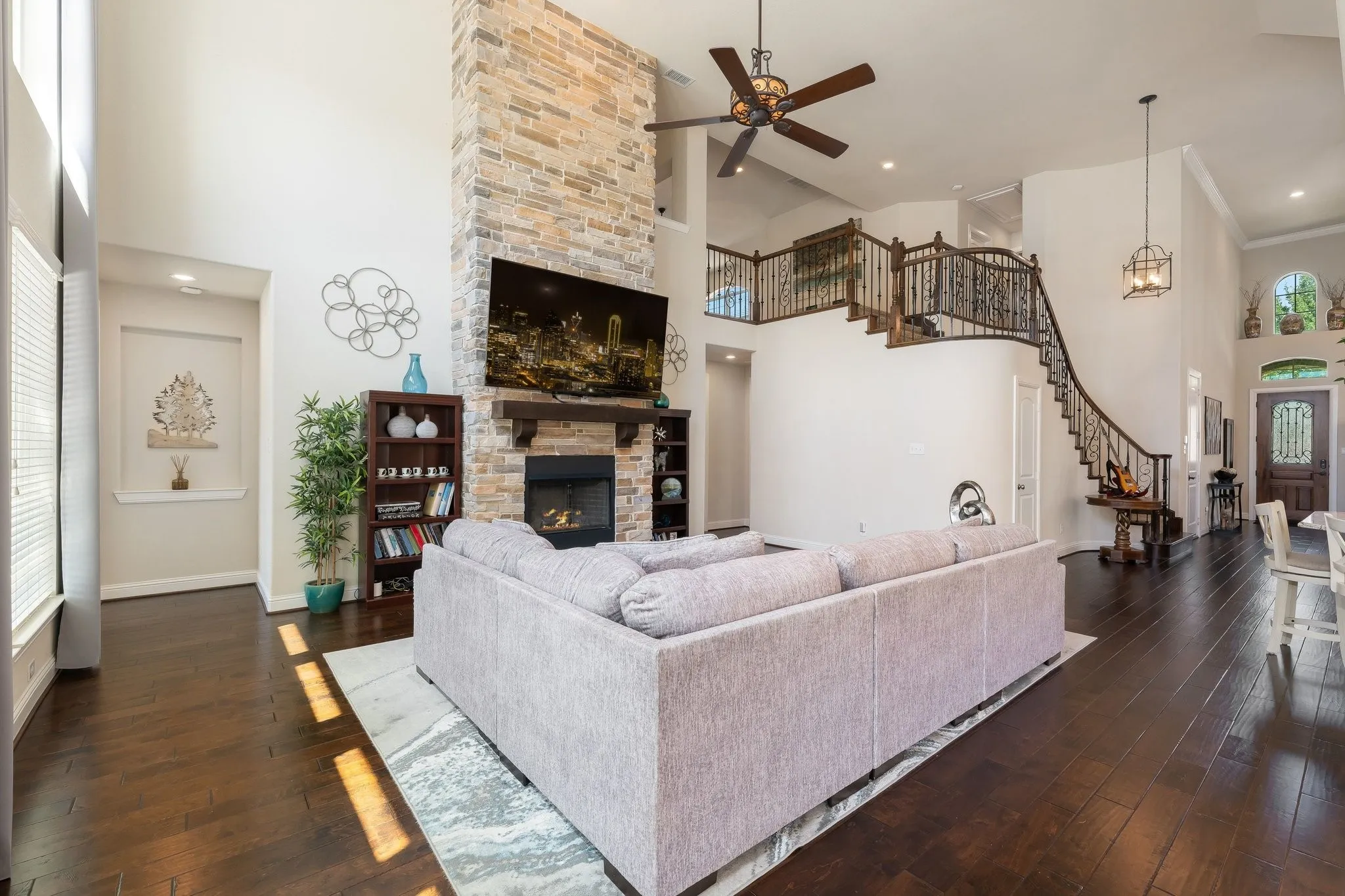 Beautiful family room with stone fireplace rises towards the ceiling