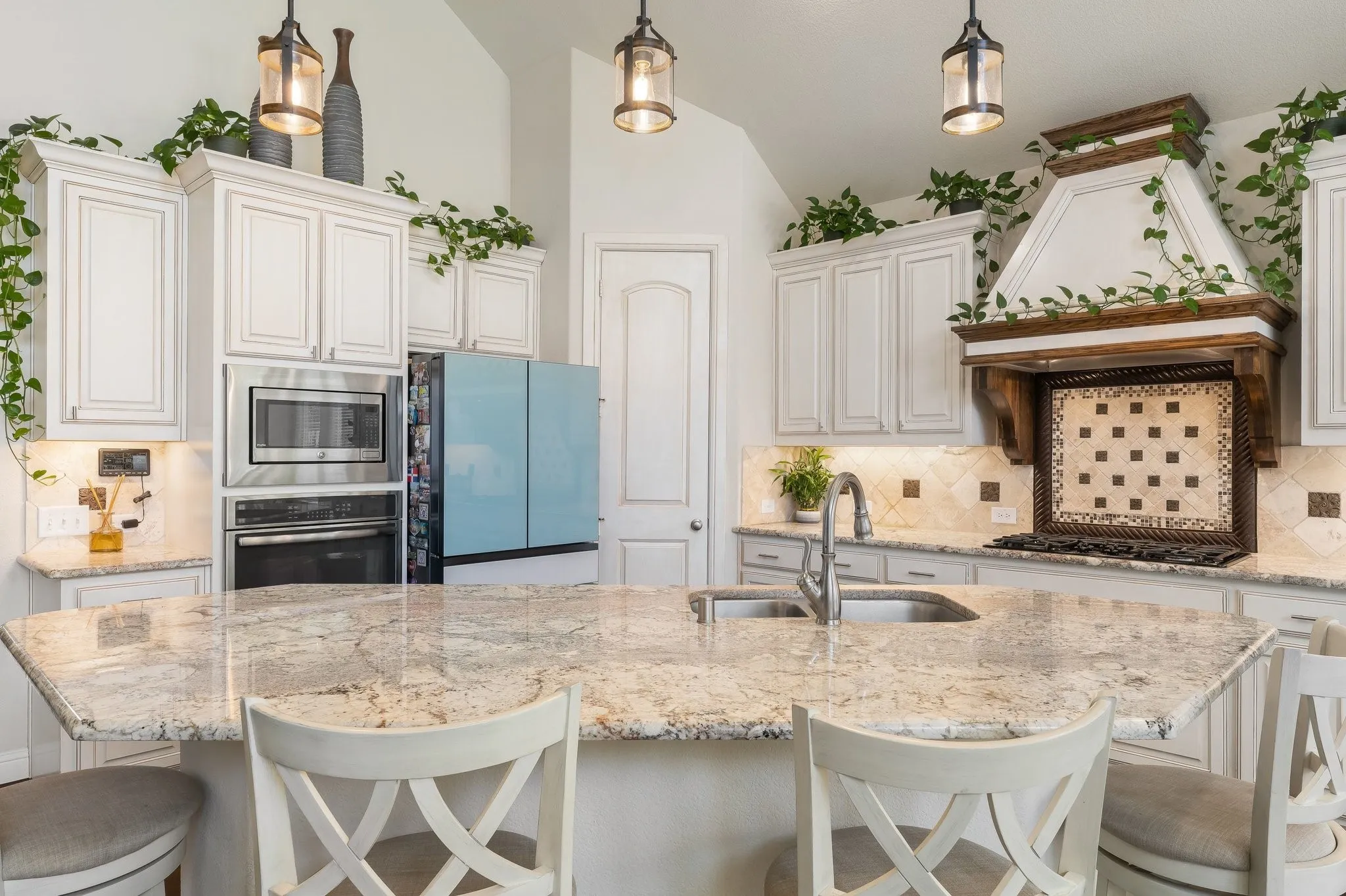 The oversized kitchen island becomes the place where everyone gathers