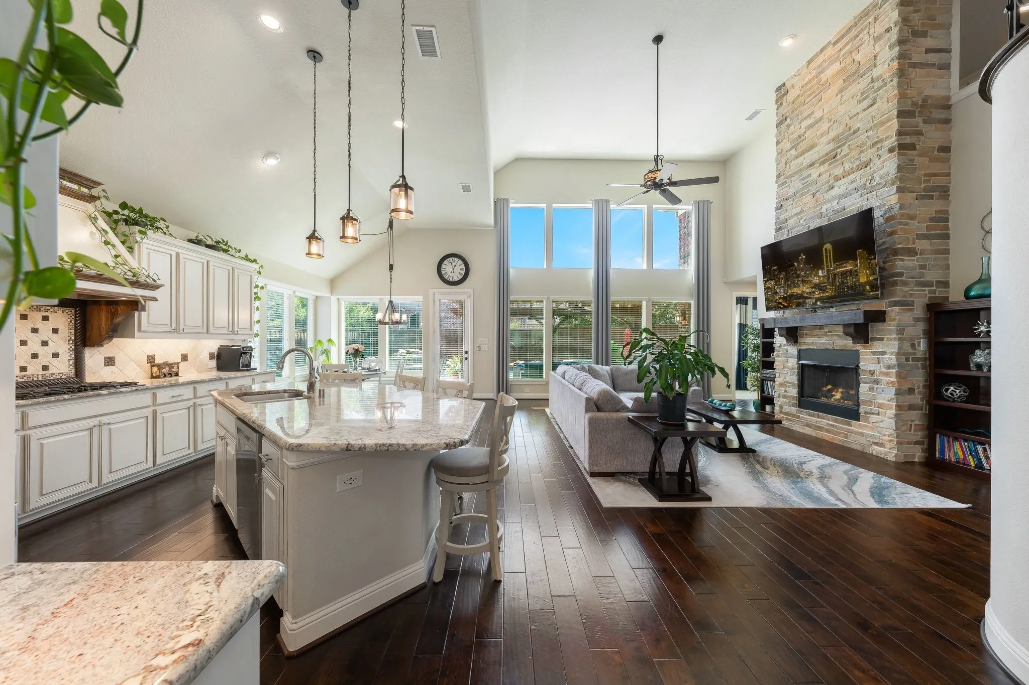 From soaring ceilings to warm stone fireplace every space feels open and inviting