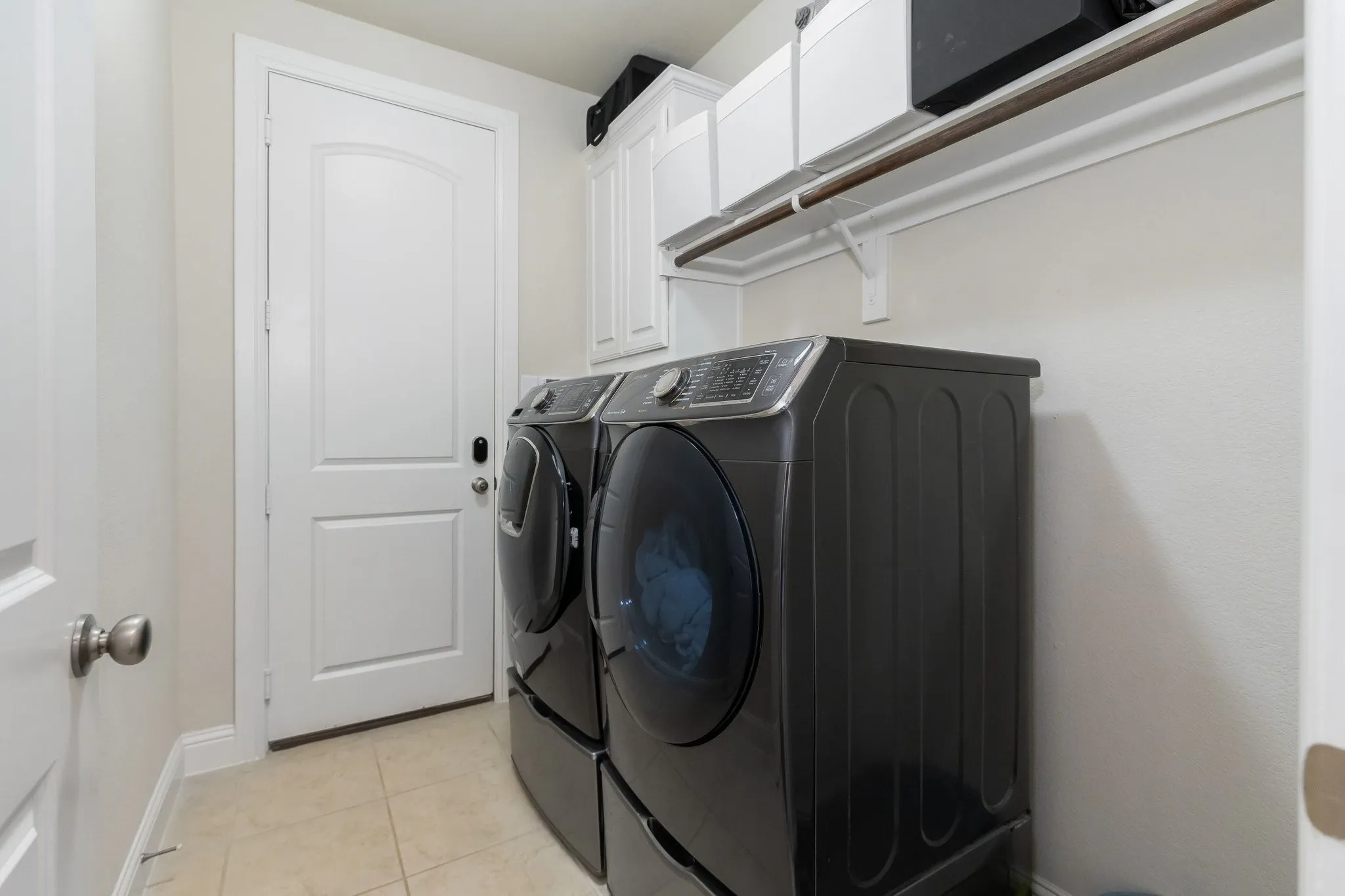 Laundry has built in cabinets and the room to store your supplies