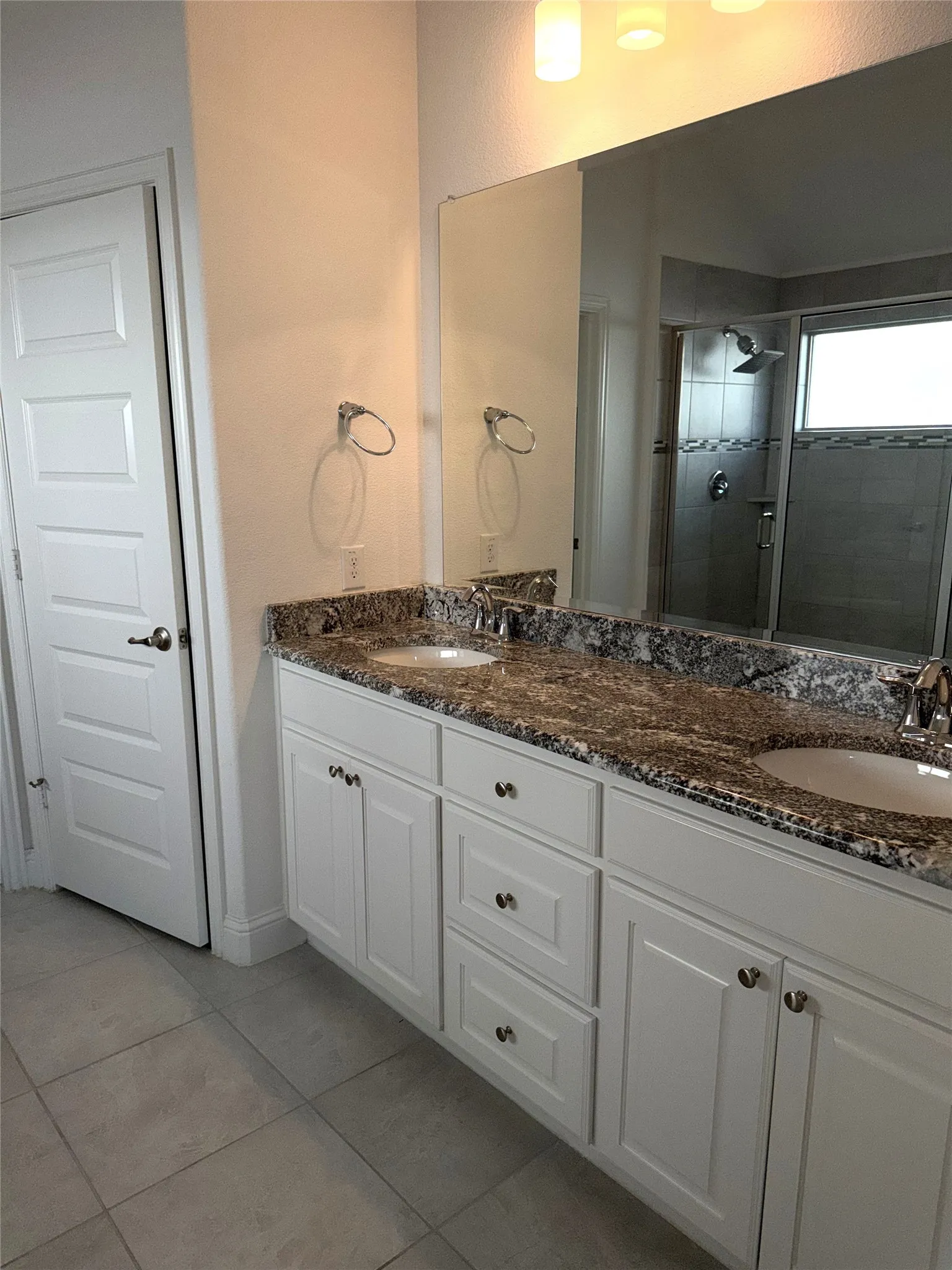 master bath with graite counters and double sinks

