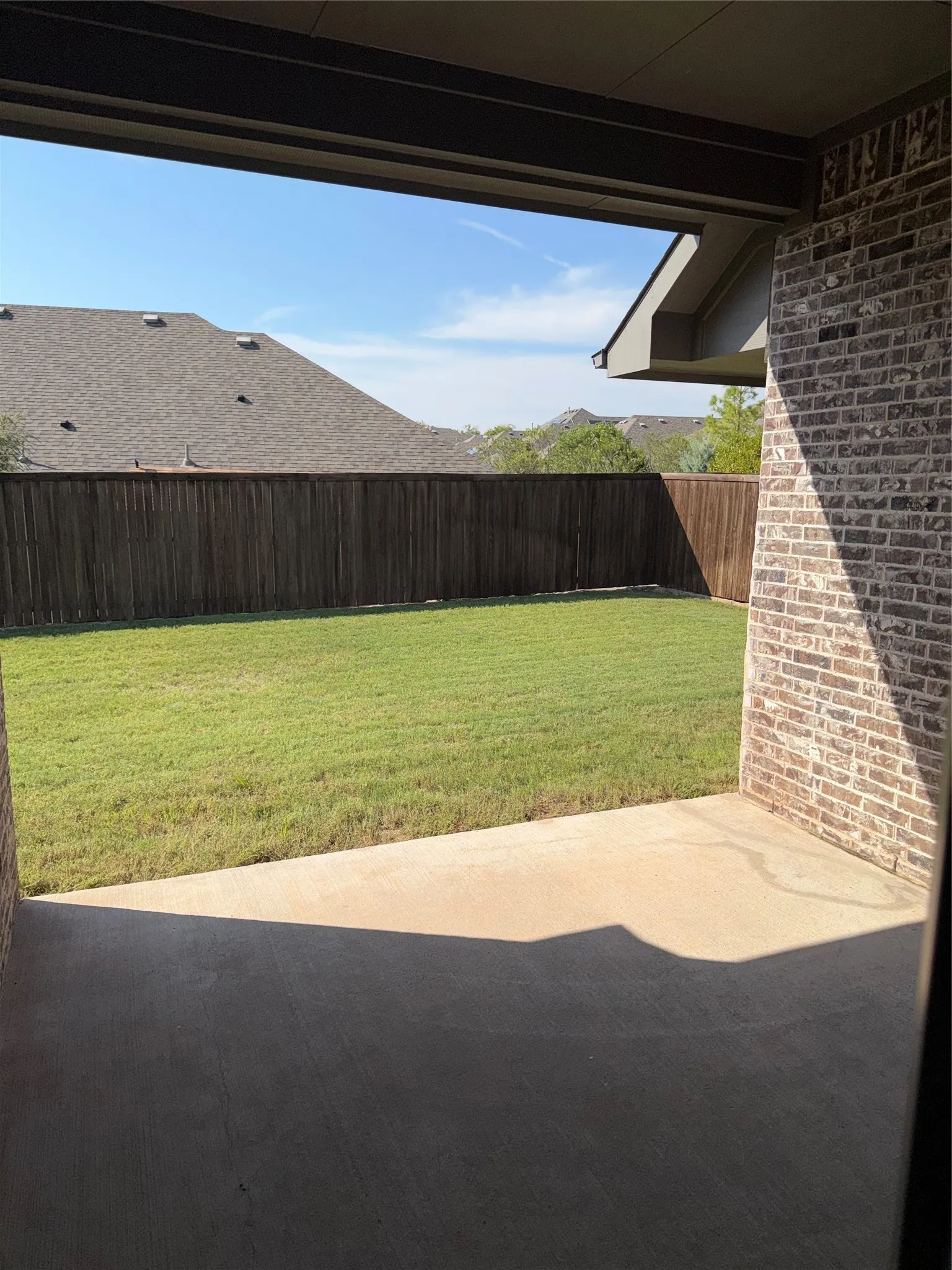 large backyard with covered patio
