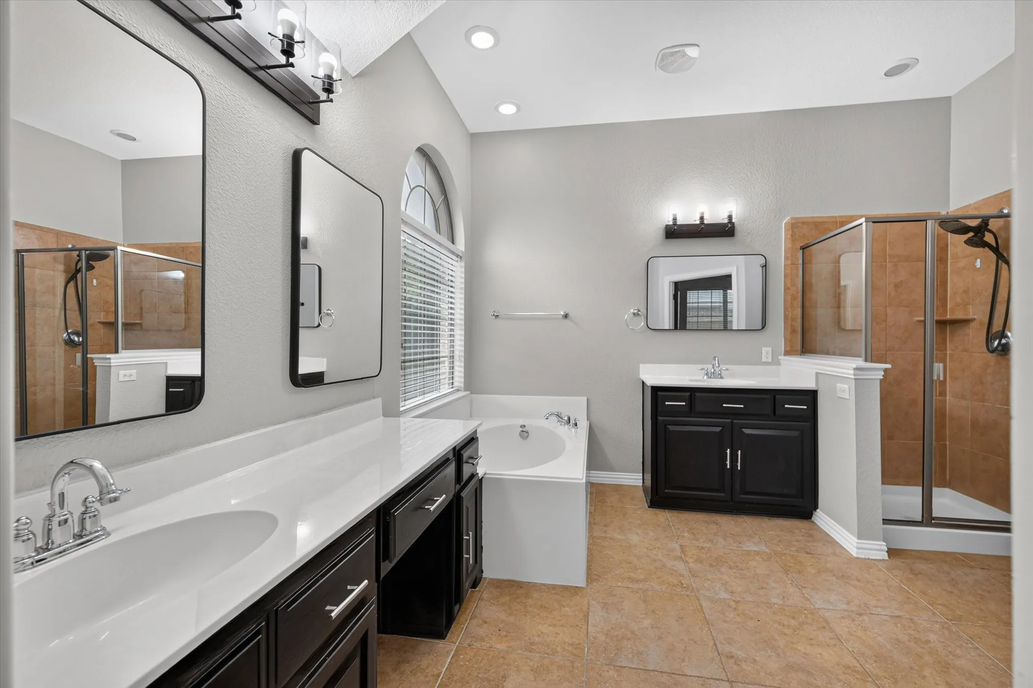 Dual walk-in showers with tiled surrounds