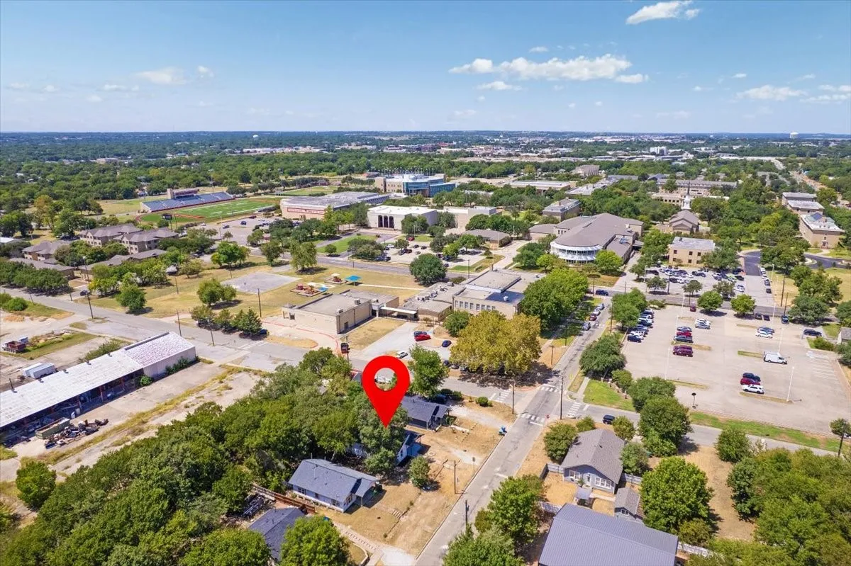 Aerial perspective showcasing established neighborhood with mature trees