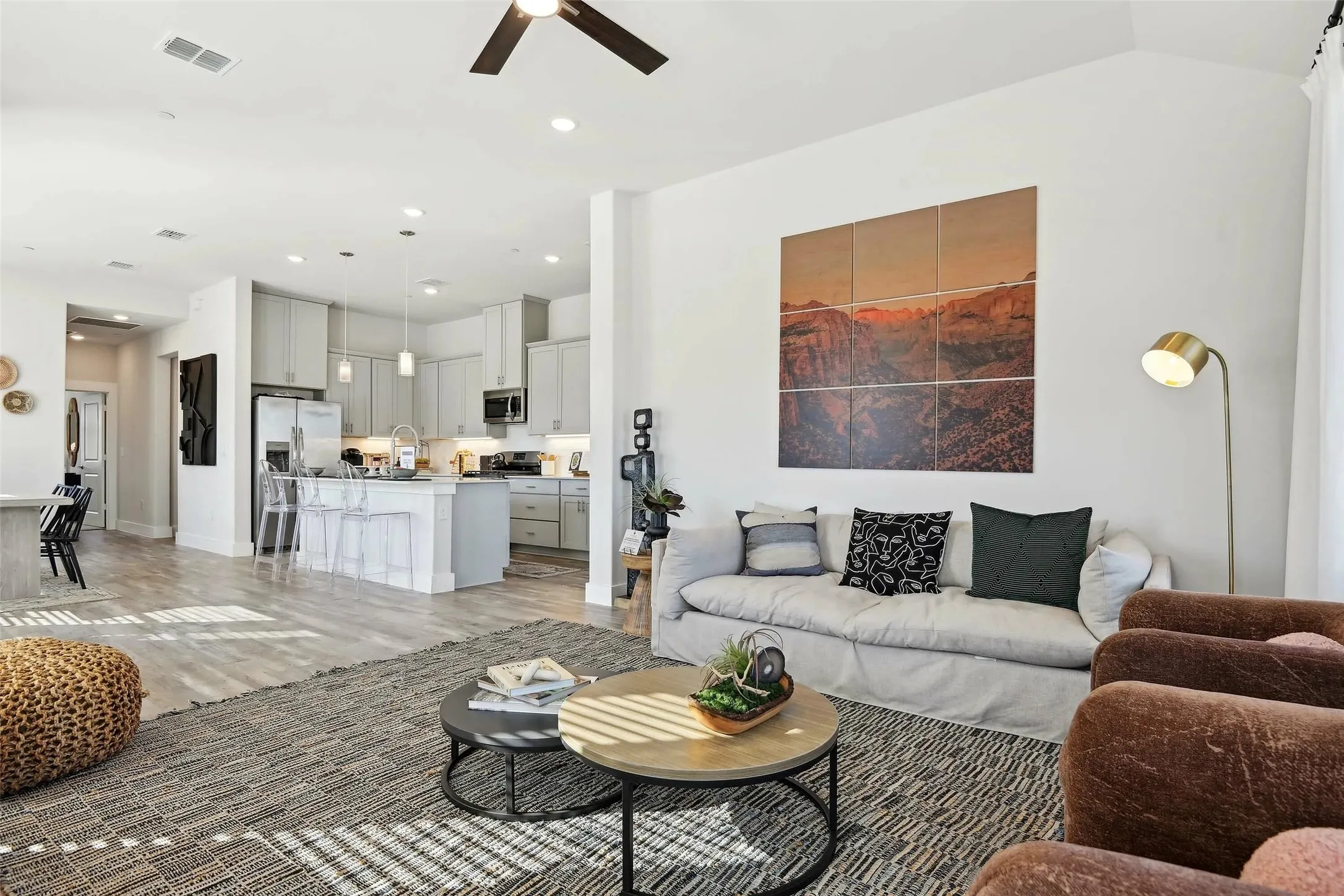 Open-concept living space with wood-finish flooring, a ceiling fan, and recessed lighting
