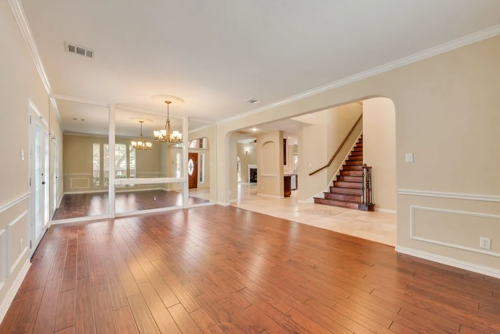 View of Entry, Formal living ,Dining, Wood Staircase to upstairs.