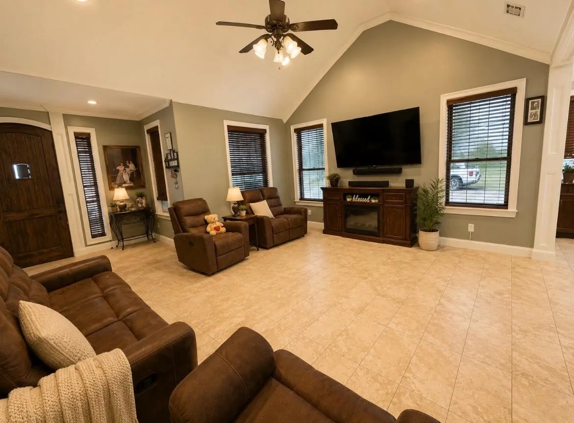 Vaulted ceiling with a ceiling fan, recessed lighting, tile flooring, and a decorative fireplace