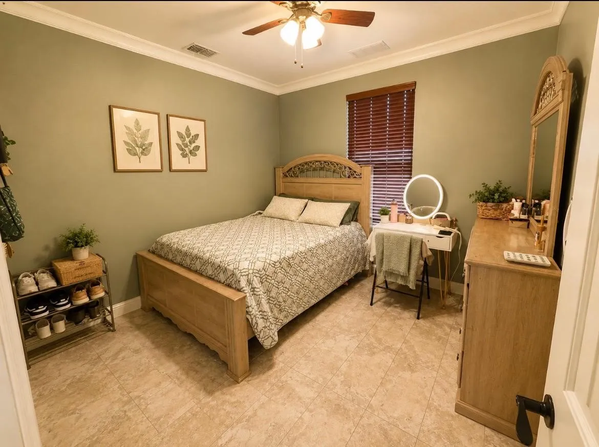 Neutral-toned tile flooring, crown molding, and a ceiling fan with light fixture