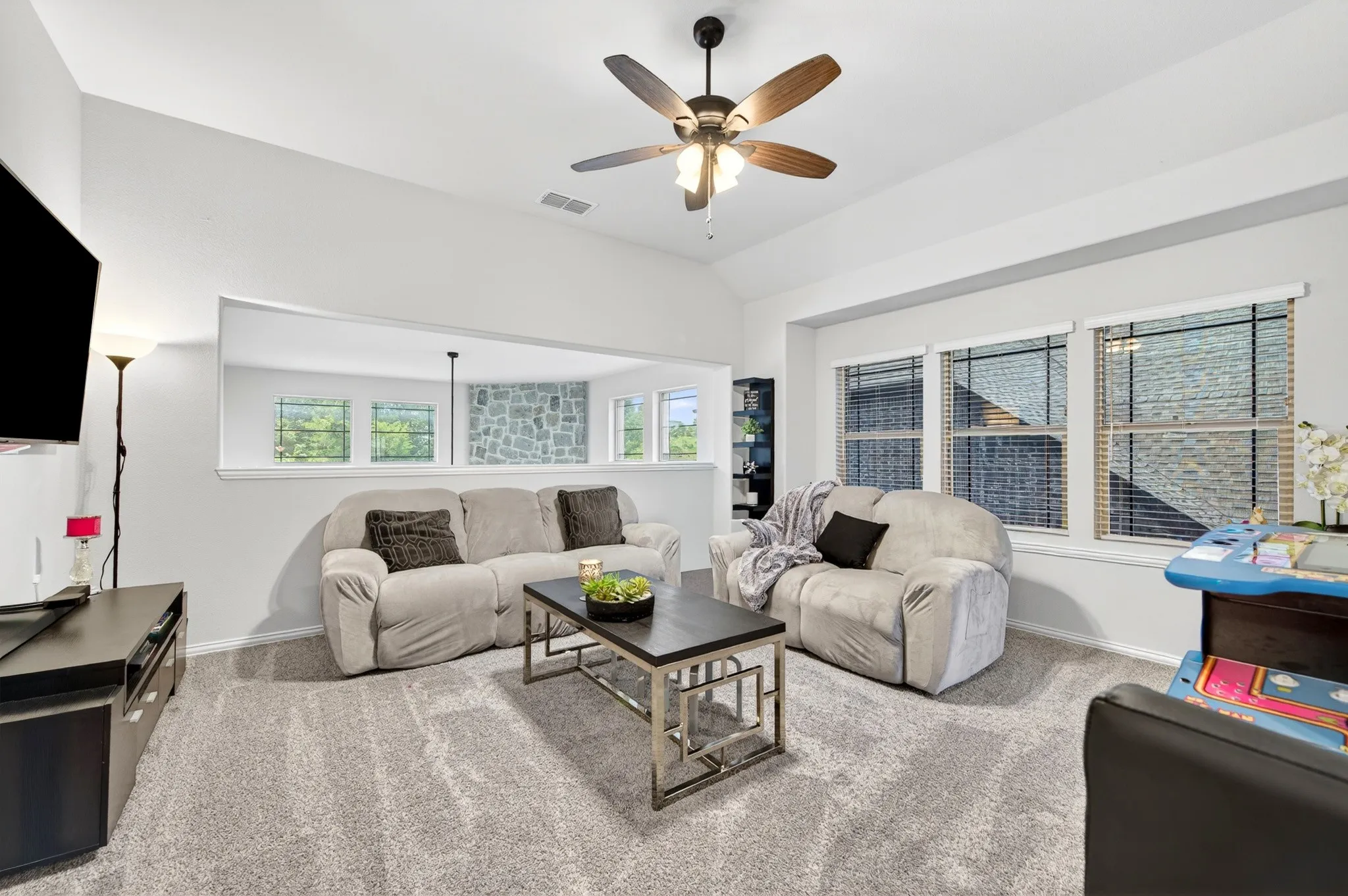 Game room with oversized windows overlooks main living area