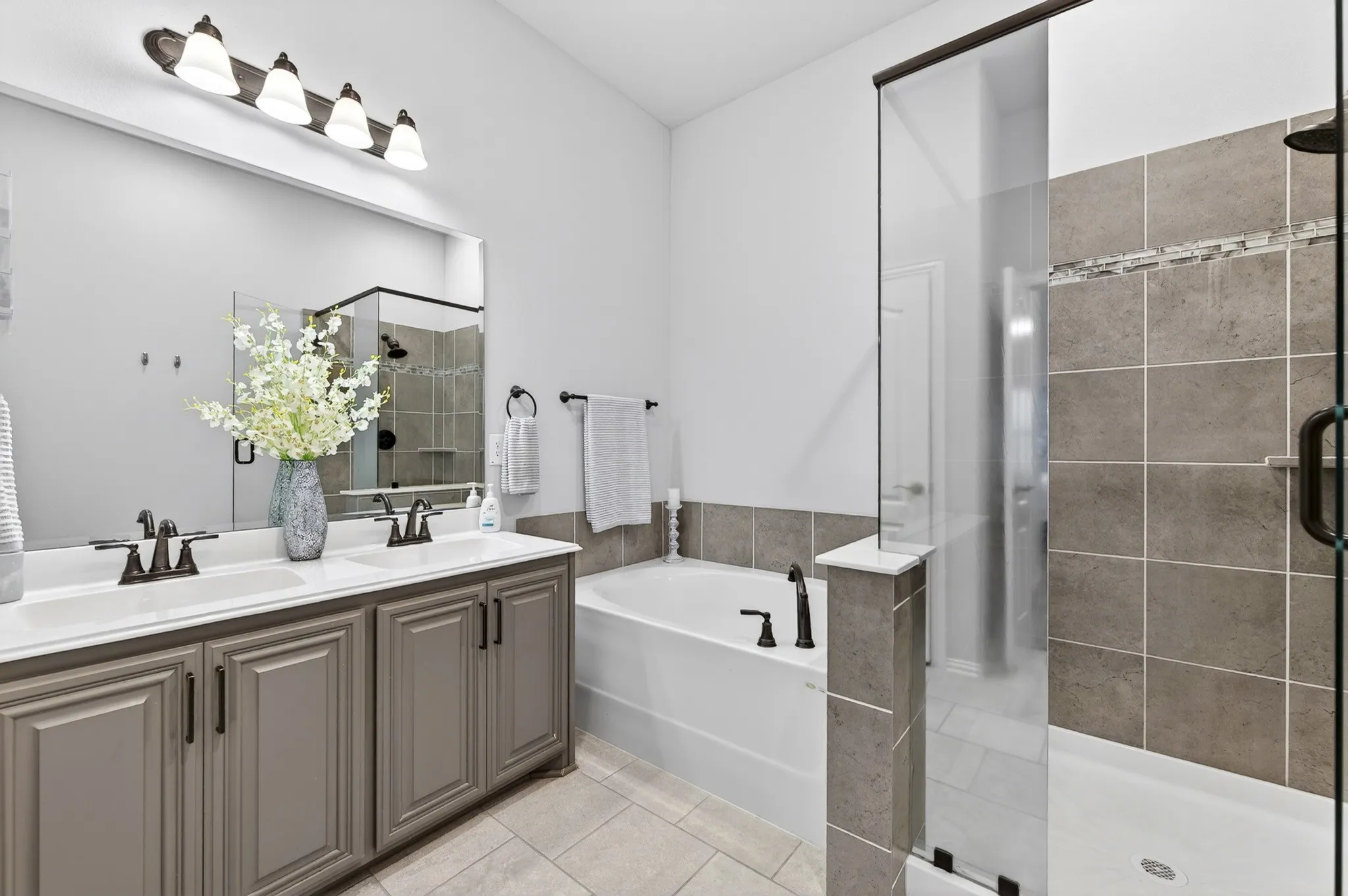 Second Primary Bath has soaking tub, shower and two sinks in vanity.  Water closet has a door.