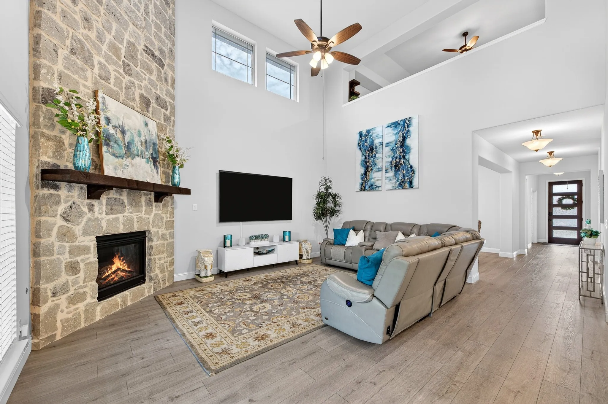Living room with over 20 foot ceilings and floor to ceiling stone fireplace.