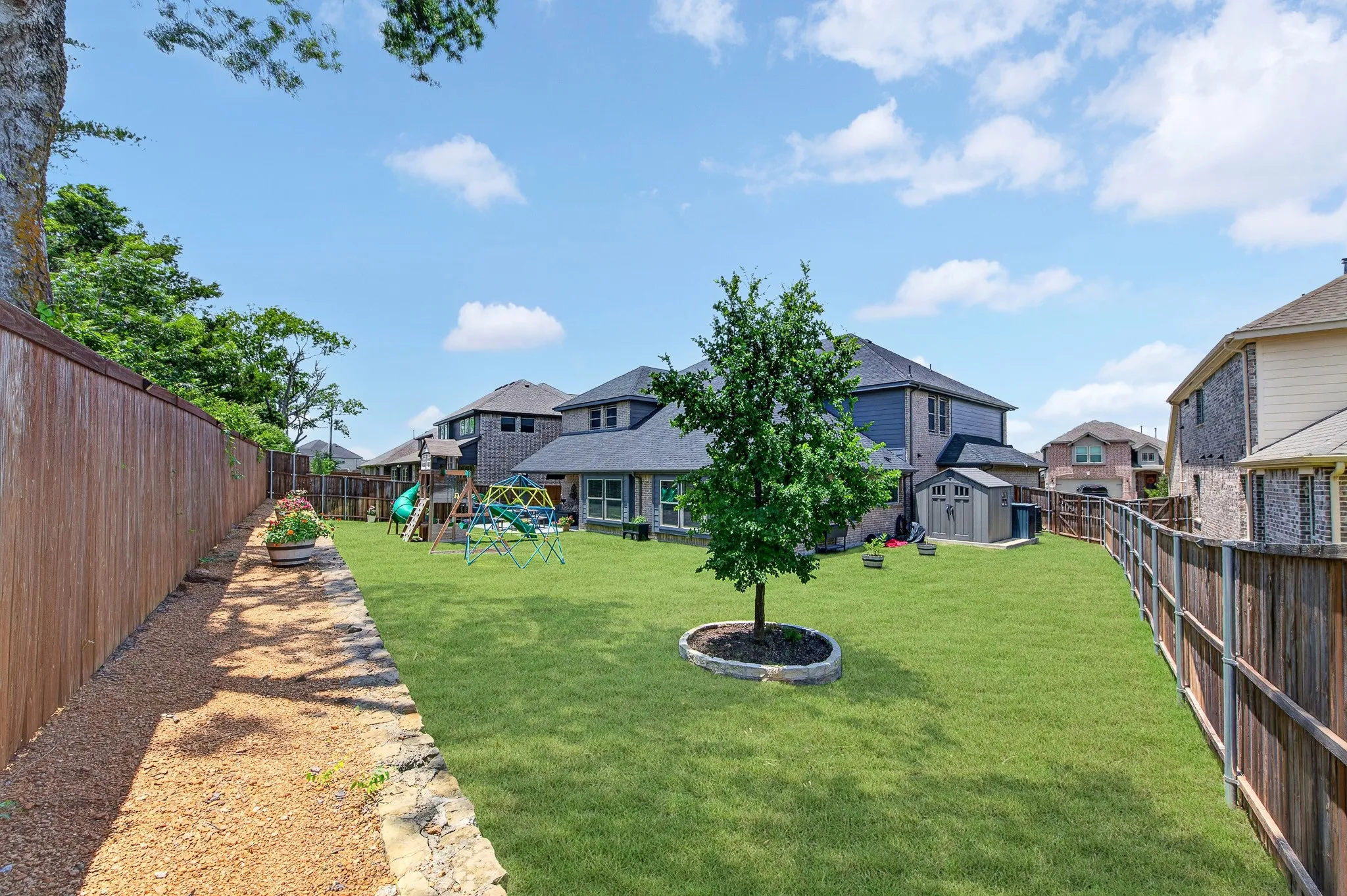 Large backyard with grass.
