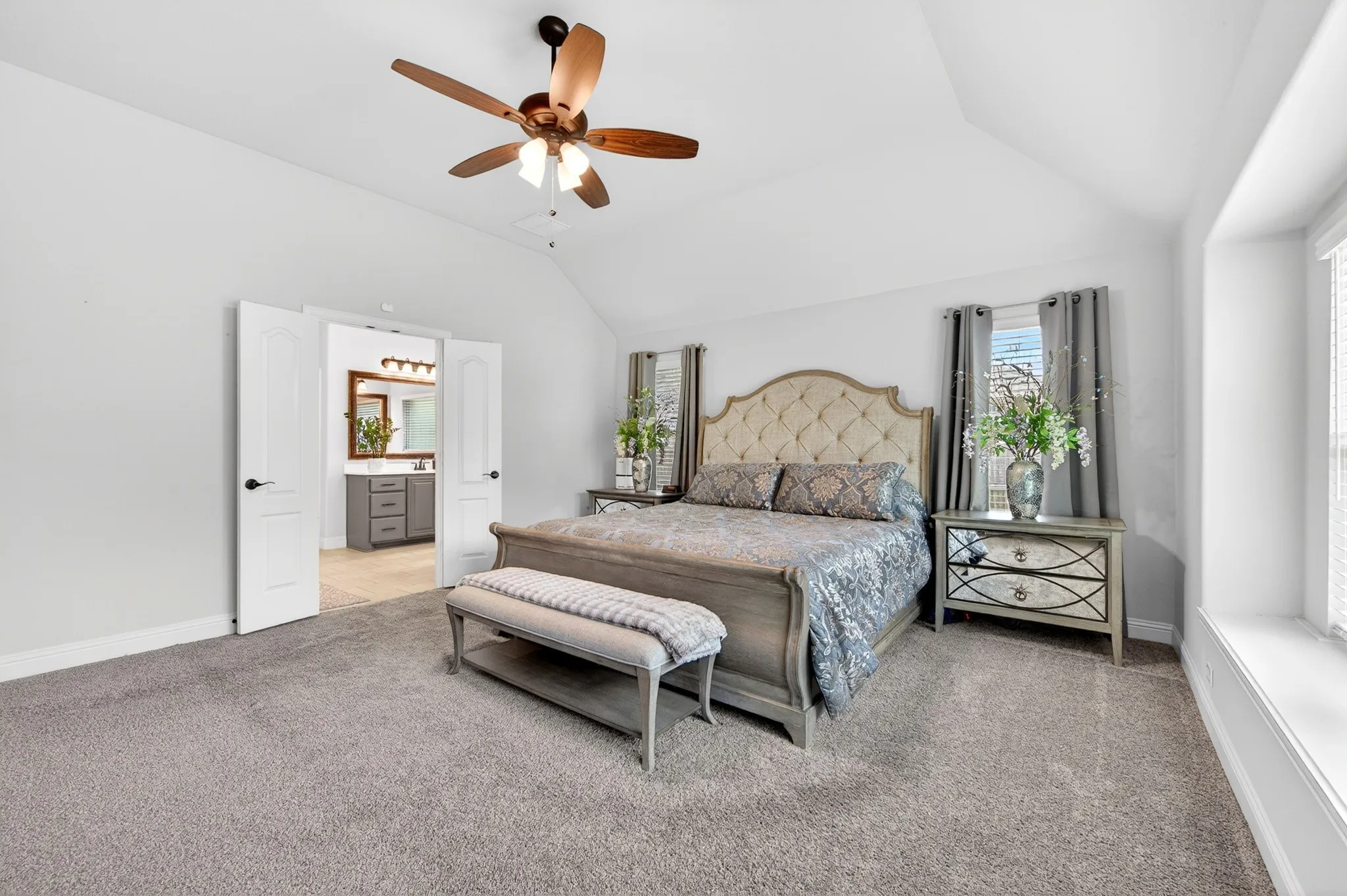 Primary bedroom with double doors leading to spa-like Primary Bath