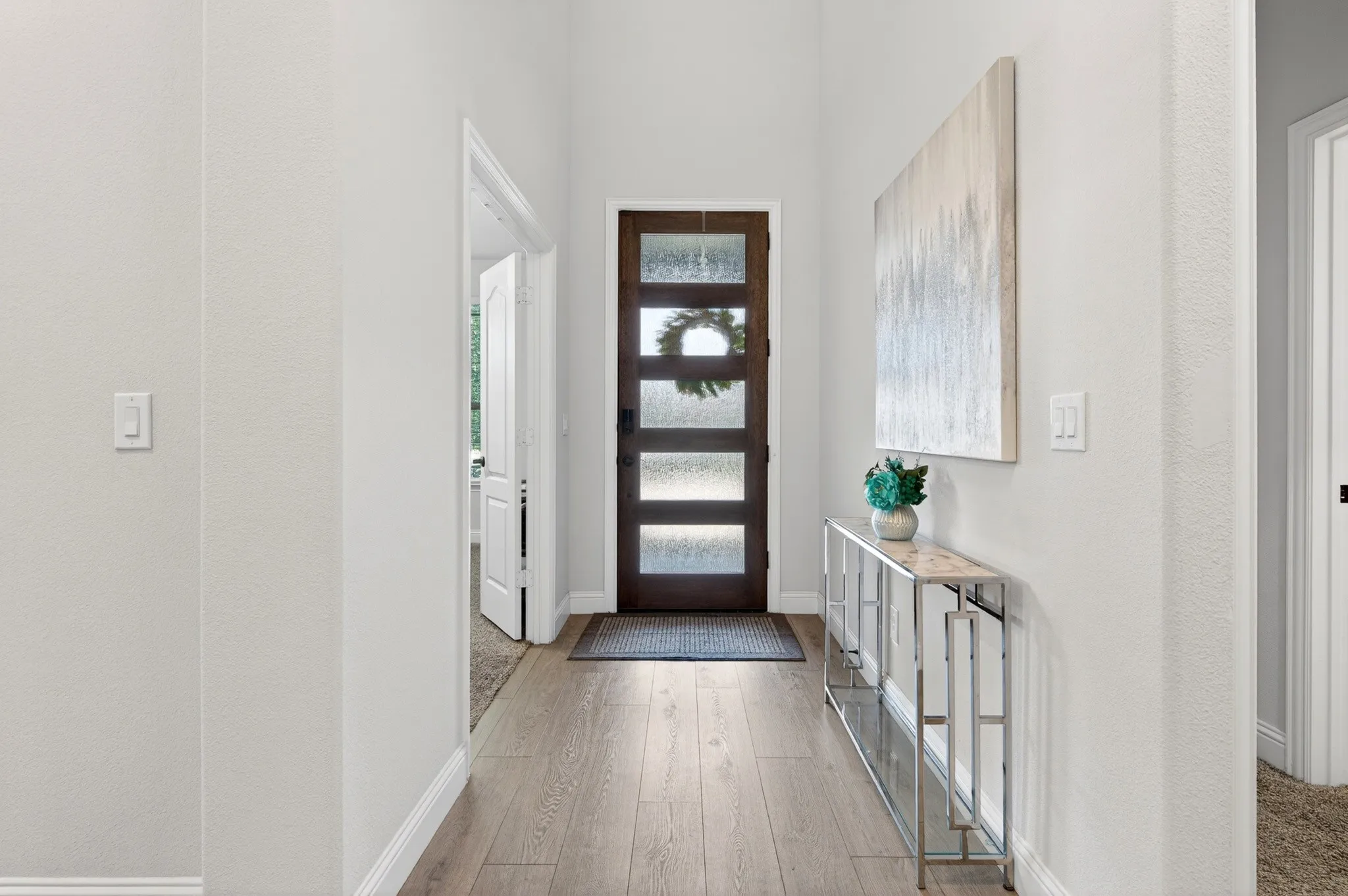 Wide entry with custom front door.