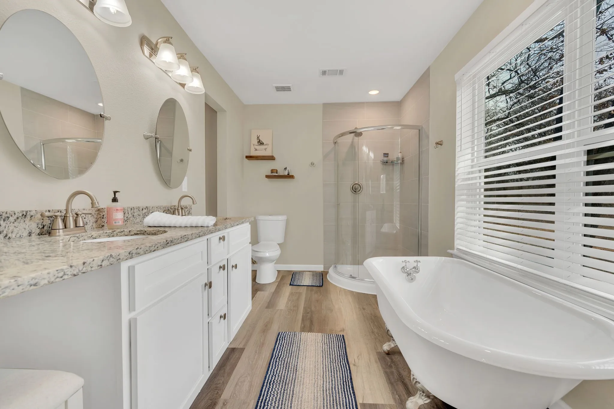 Double vanity with granite-style countertop, dual sinks, and individual mirrors