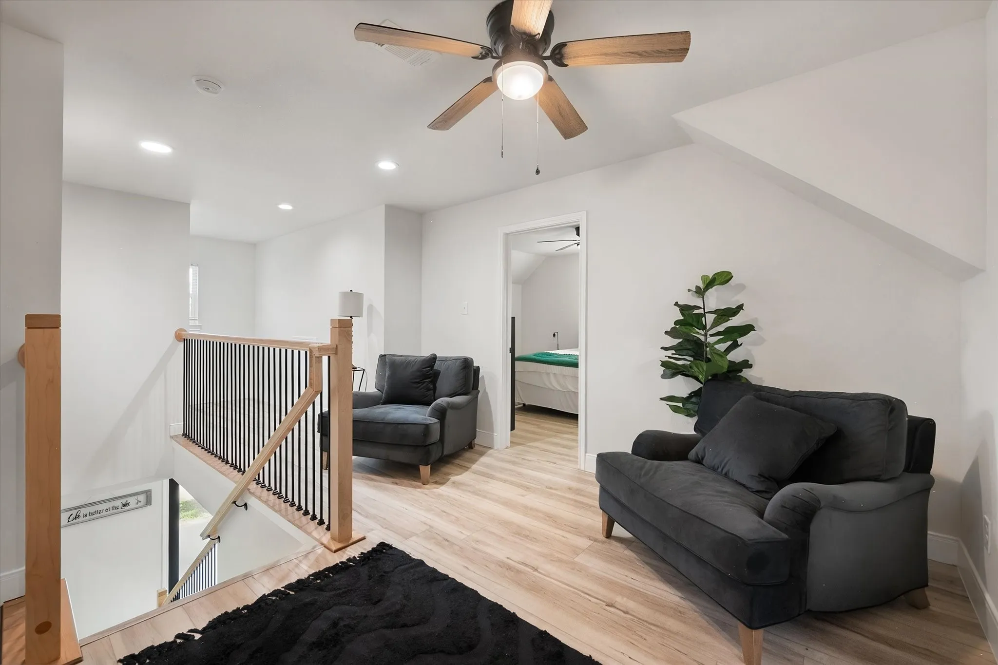 Upstairs family room creates a comfortable second gathering area with ceiling fan, and flexible space for relaxing or quiet conversations.