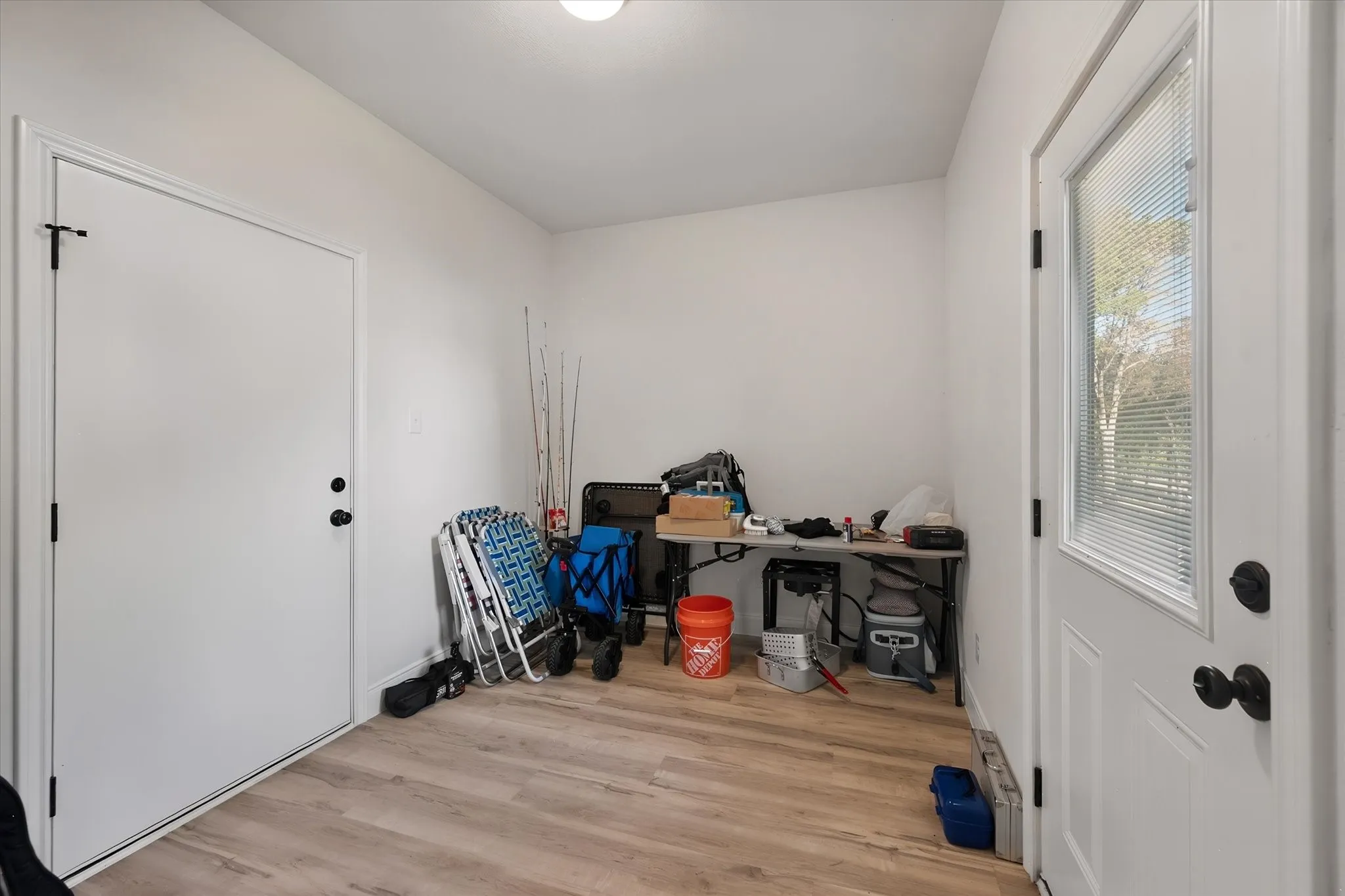 Functional mudroom provides a convenient secondary entrance and flexible storage space for everyday necessities and lake-day gear.