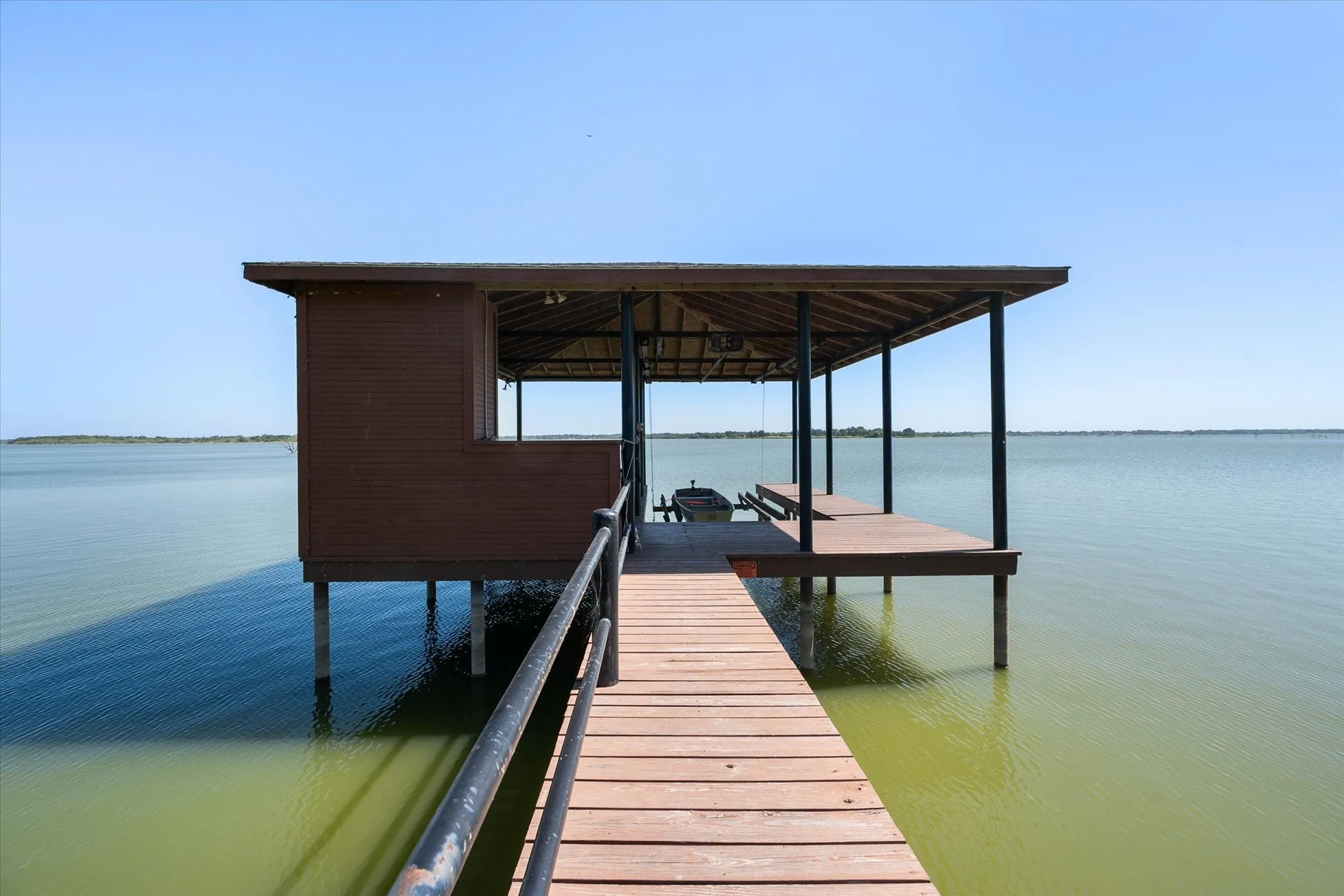 Private covered boathouse extends into Richland Chambers Lake, providing direct water access and a dedicated setting for boating and lake days.