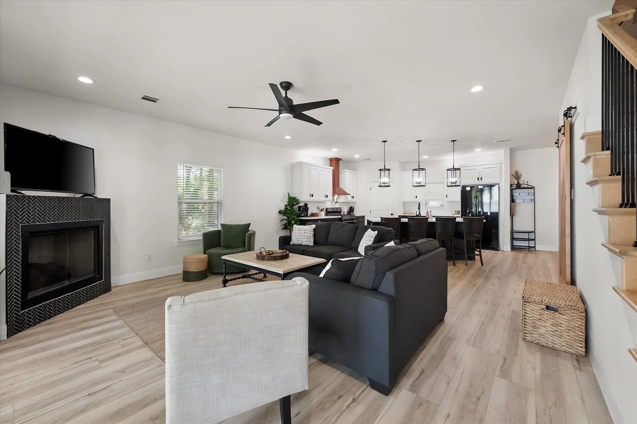 Open-concept living and kitchen design creates an inviting entertaining space with modern farmhouse finishes and abundant natural light.